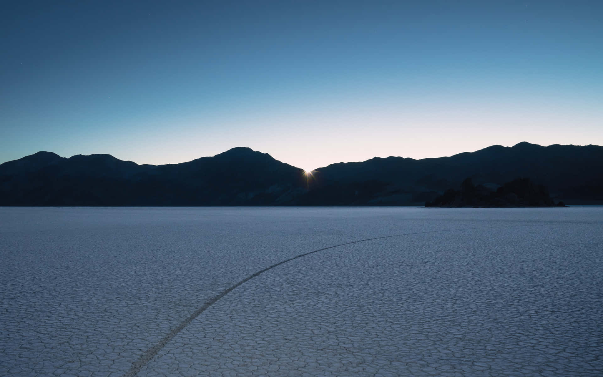 Sunrise Over Cracked Desert Background