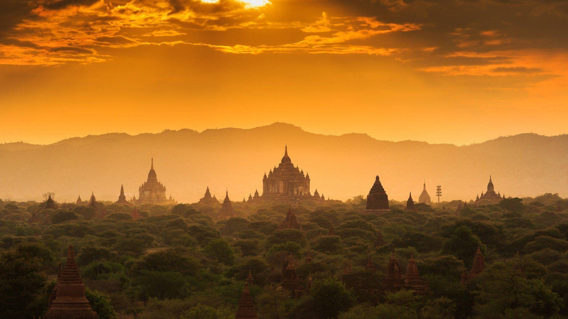 Sunset Beyond Myanmar Temples Background