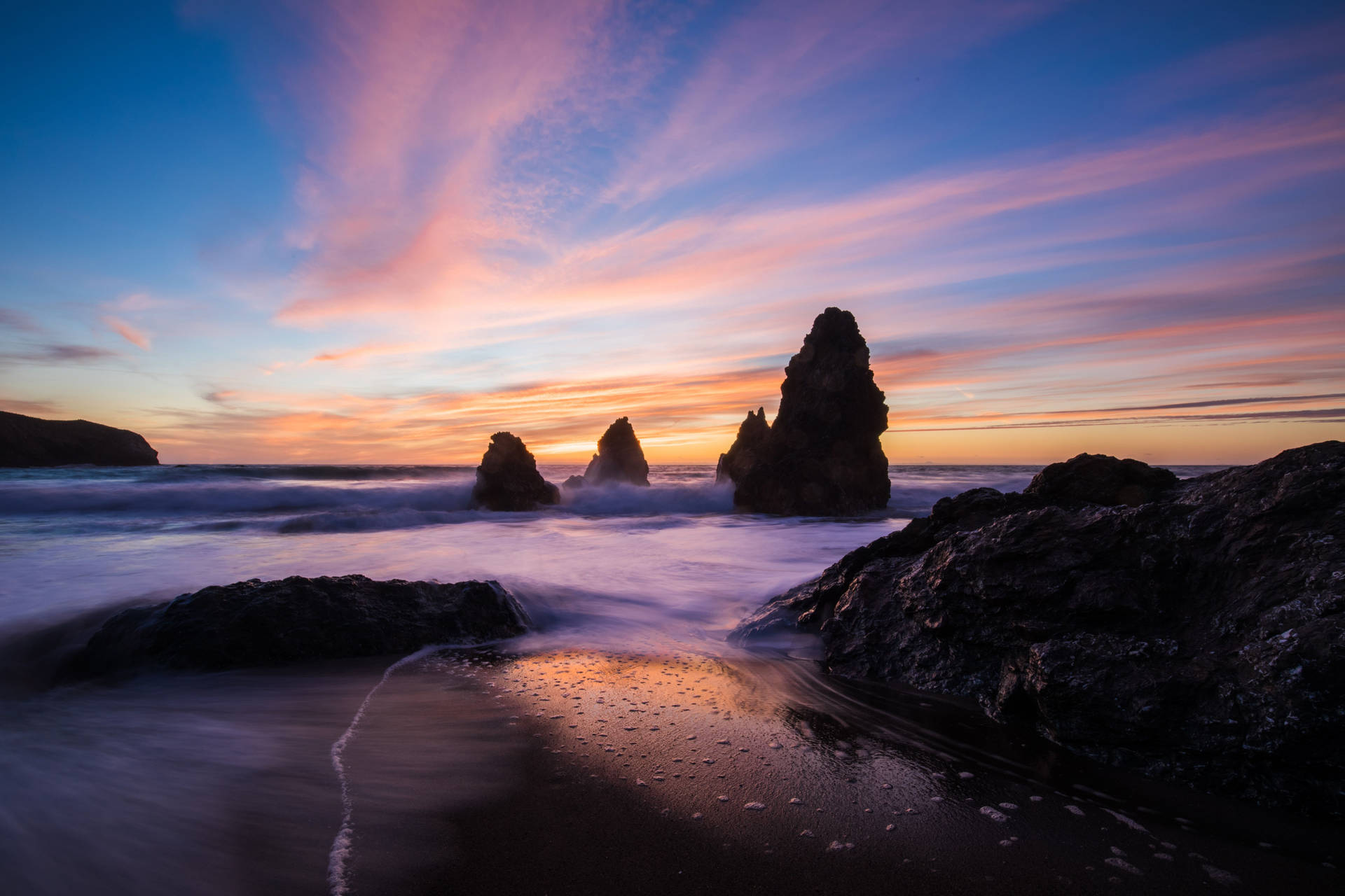 Sunset Ocean Rocks By Shore Background