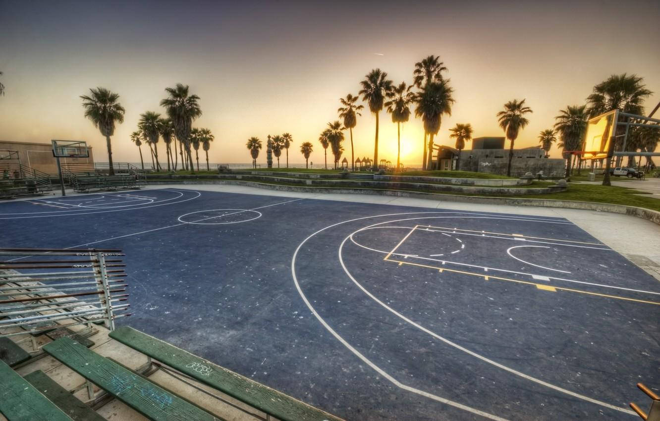 Sunset Over An Empty Basketball Court At Venice Beach