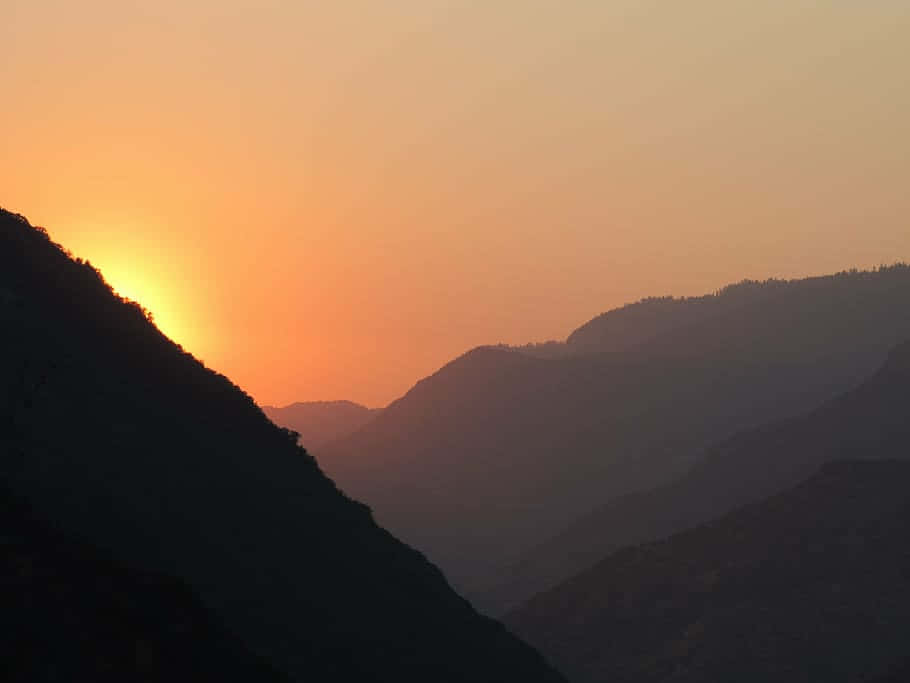 Sunset_ Over_ Mountain_ Ridges Background