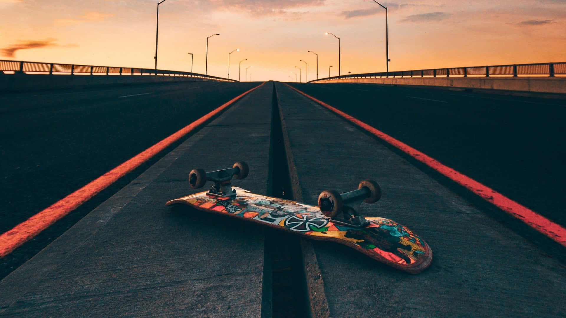 Sunset Skateboardon Empty Road Background