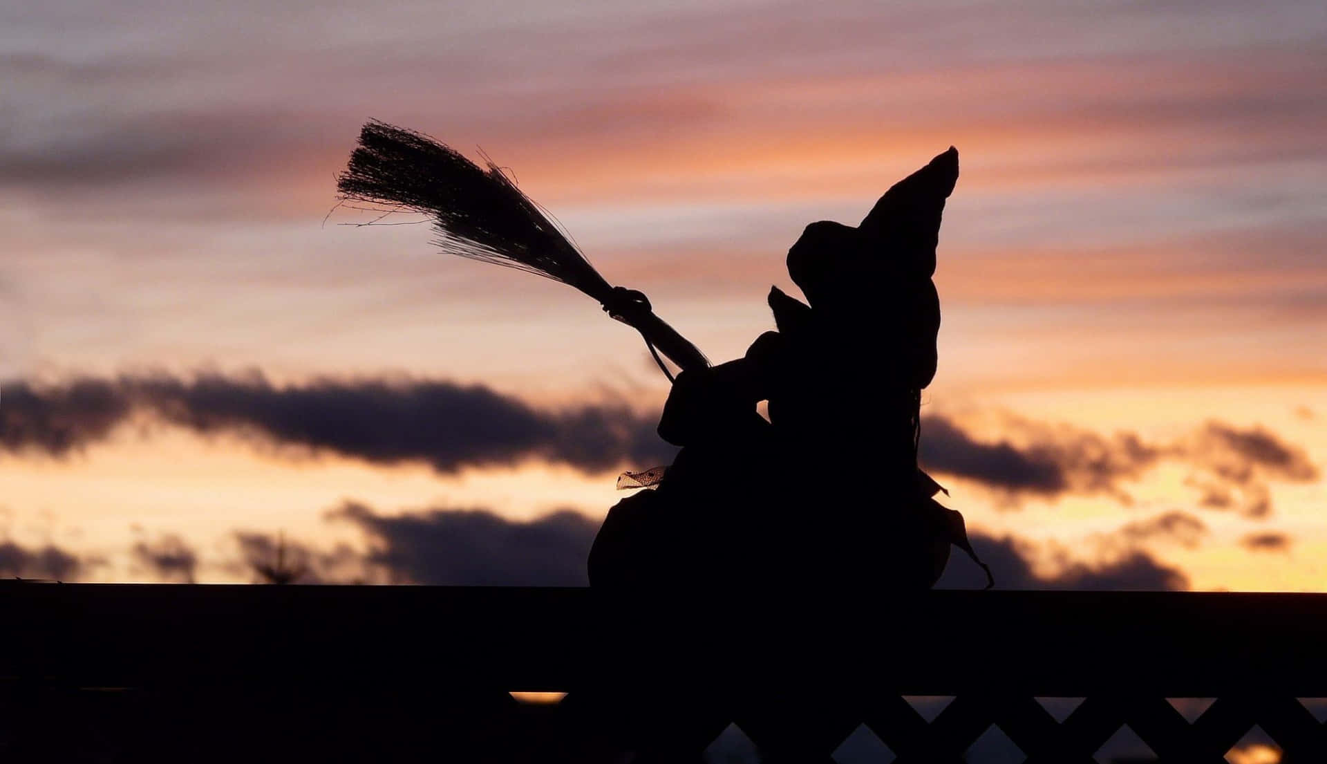 Sunset Sky Halloween Witch Silhouette Background