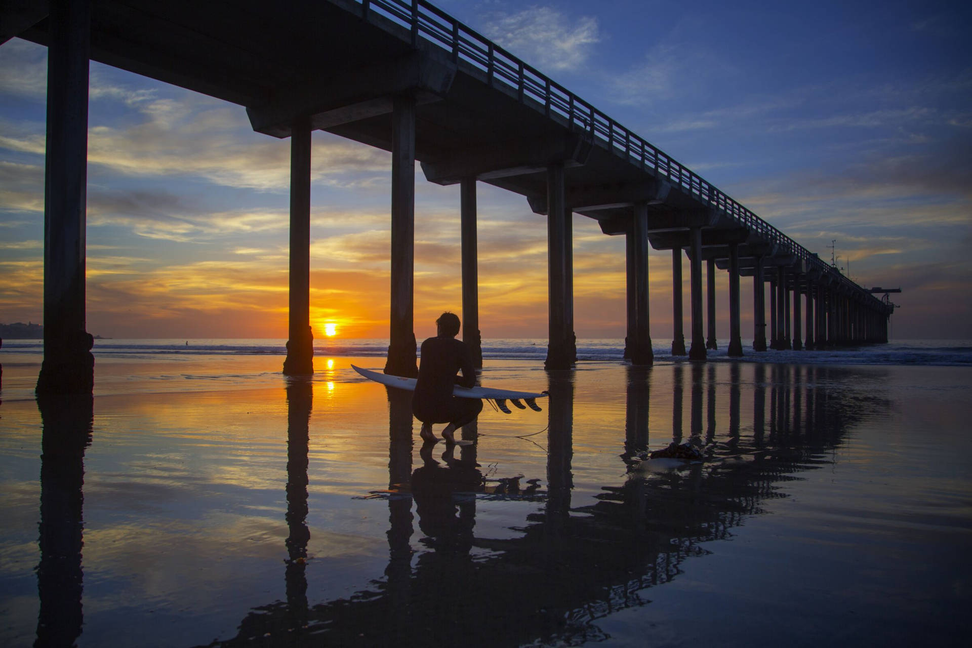 Surfer Watching Sunset At San Diego Background