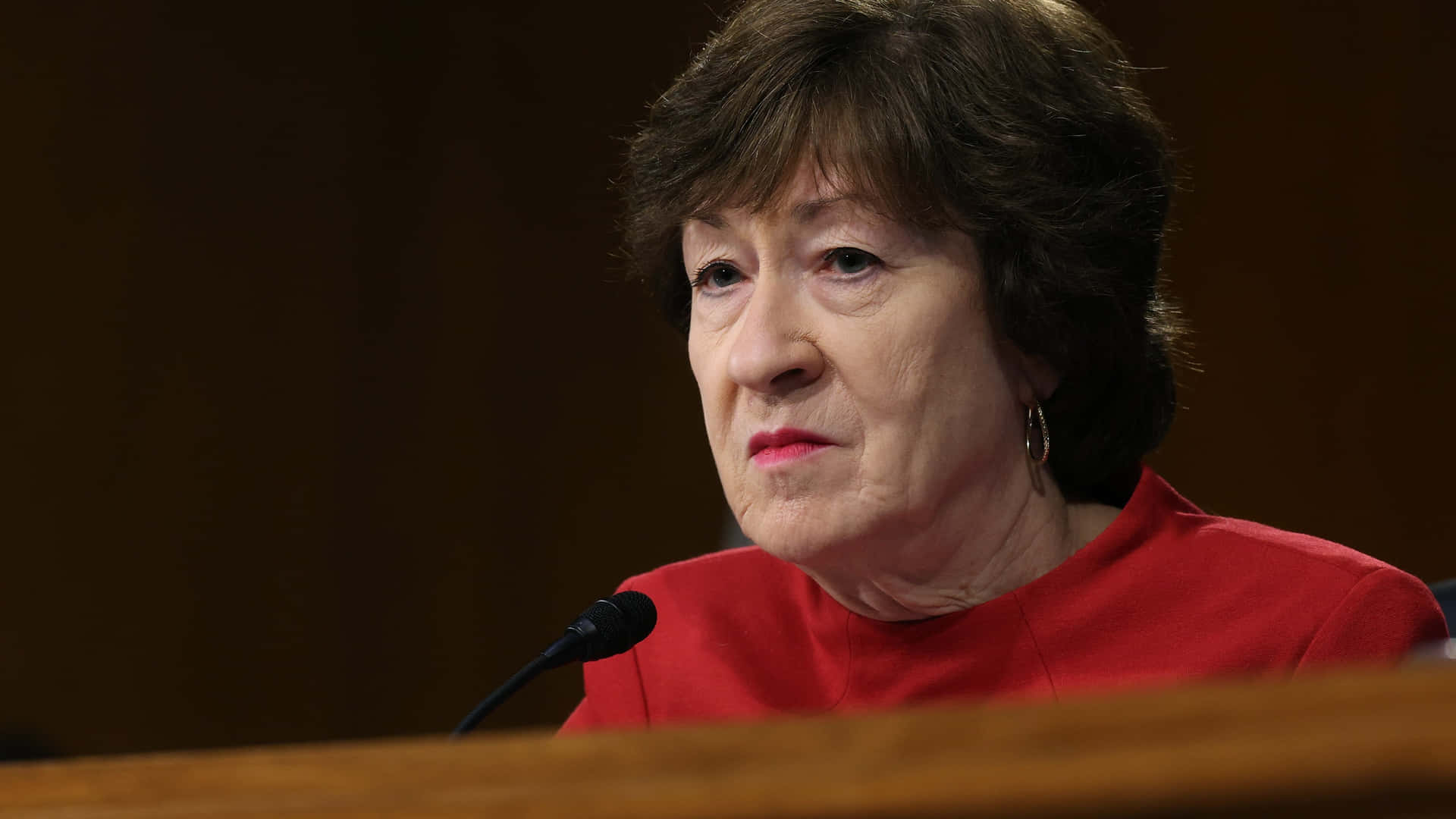Susan Collins Disinterested Look Background