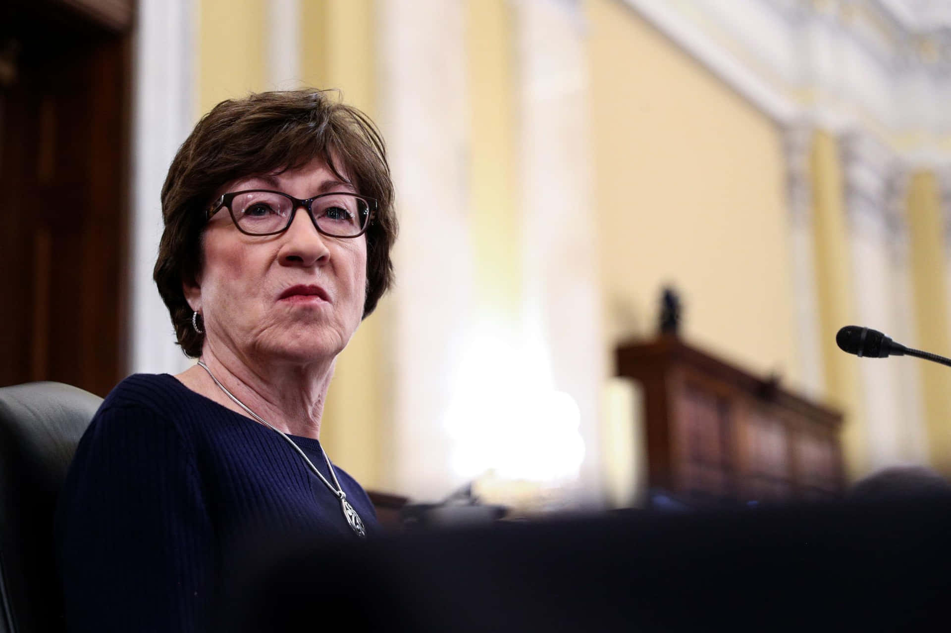 Susan Collins Looking To The Side Background