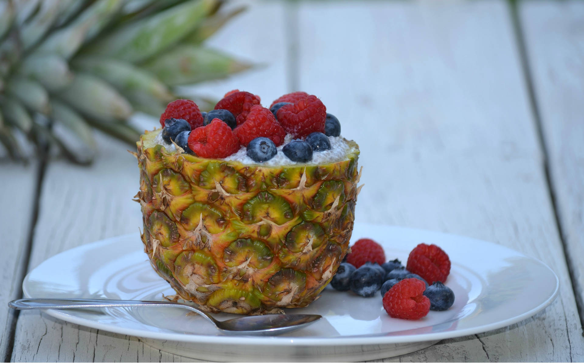 Sweet And Juicy Pineapples Topped With Fresh Berries Background