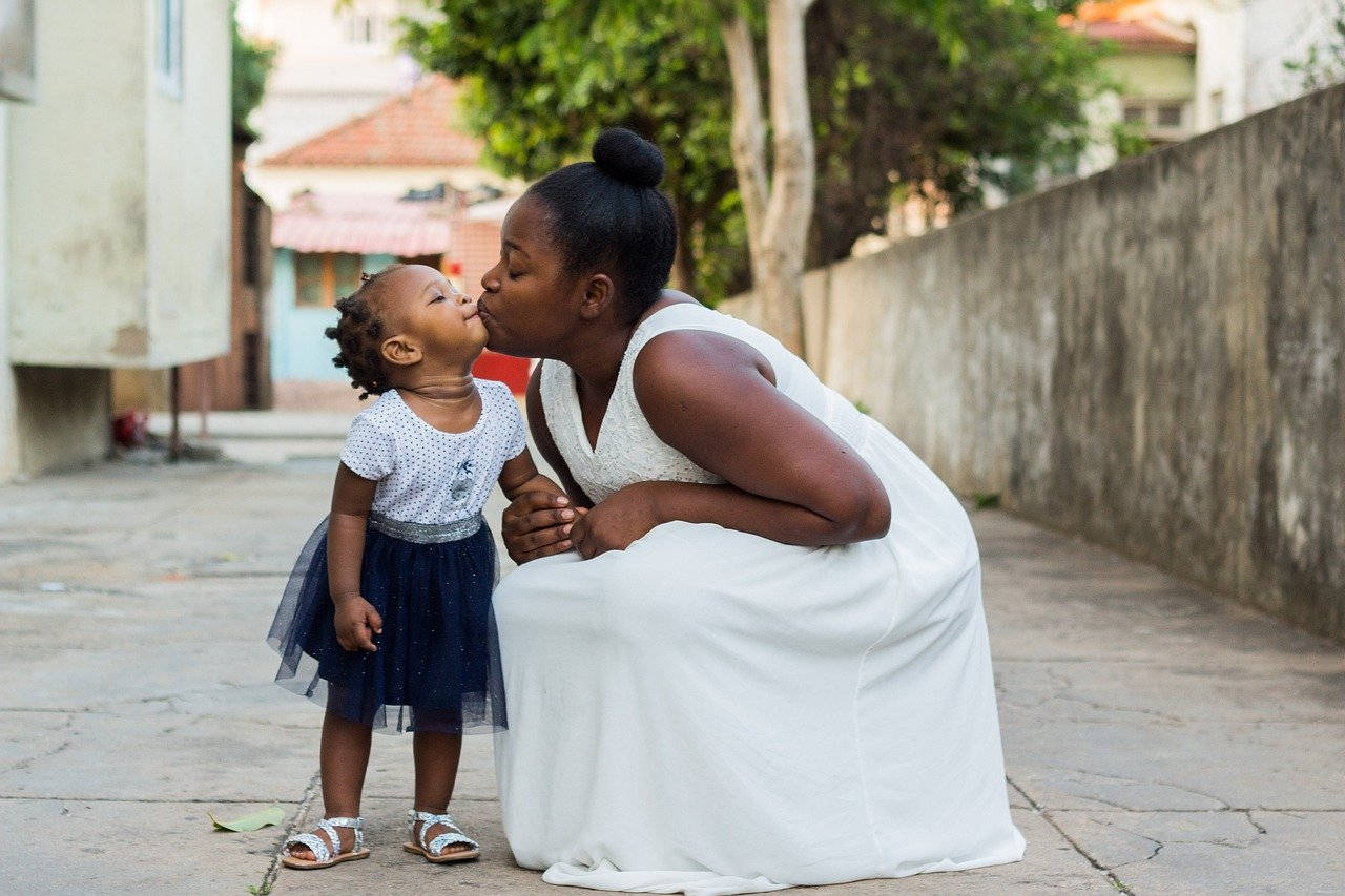 Sweetly Posed Mother And Daughter Background