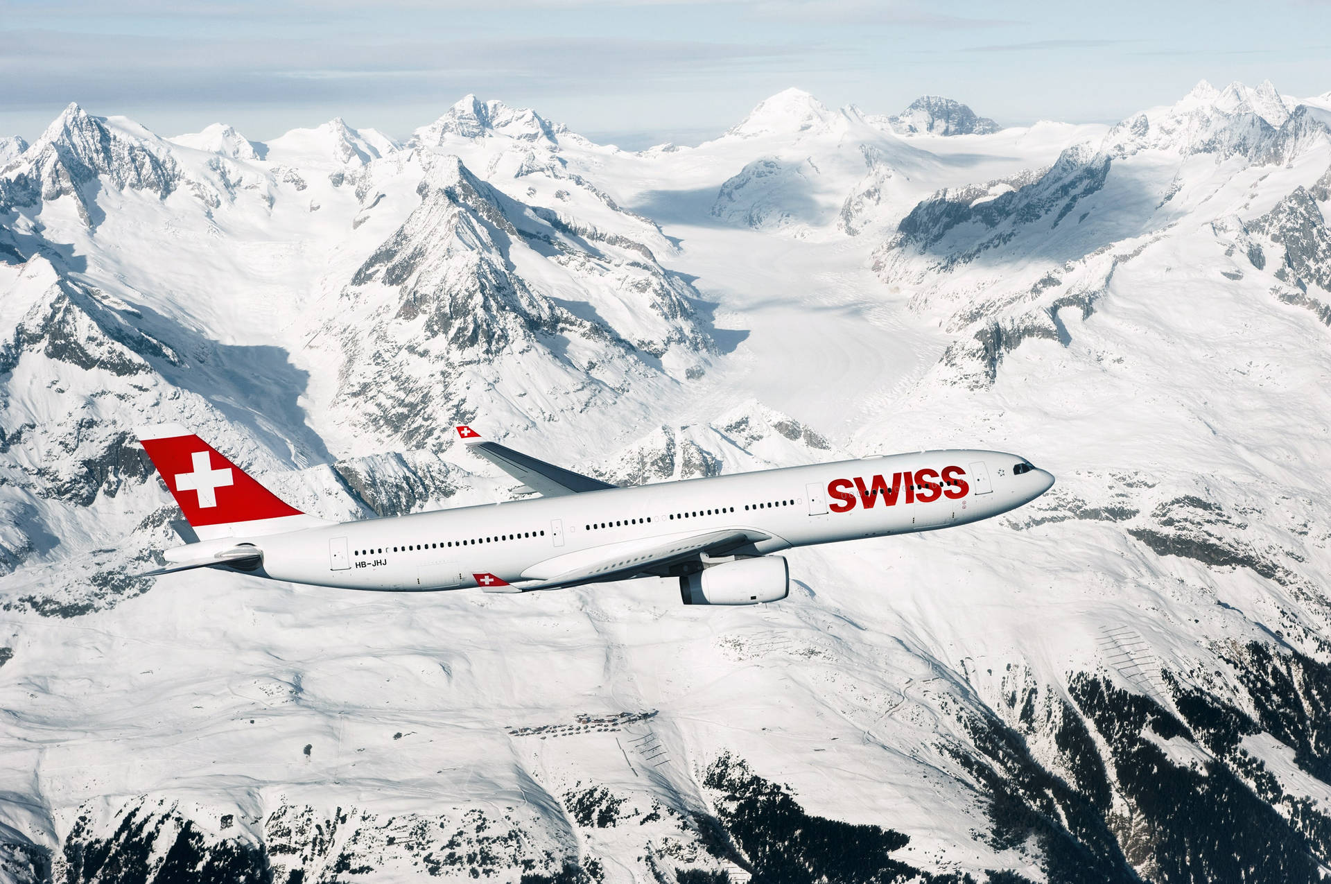 Swiss Airlines Over White Mountains Background