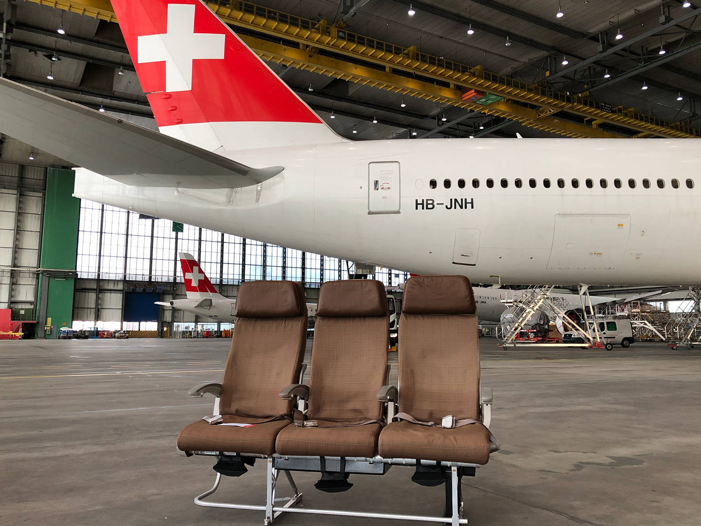 Swiss Airlines Plane With Chairs Background