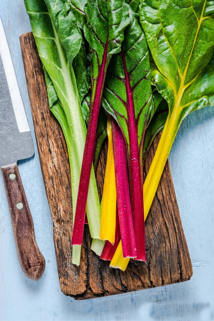 Swiss Chard Vegetable On Old Wooden Chopping Board Background