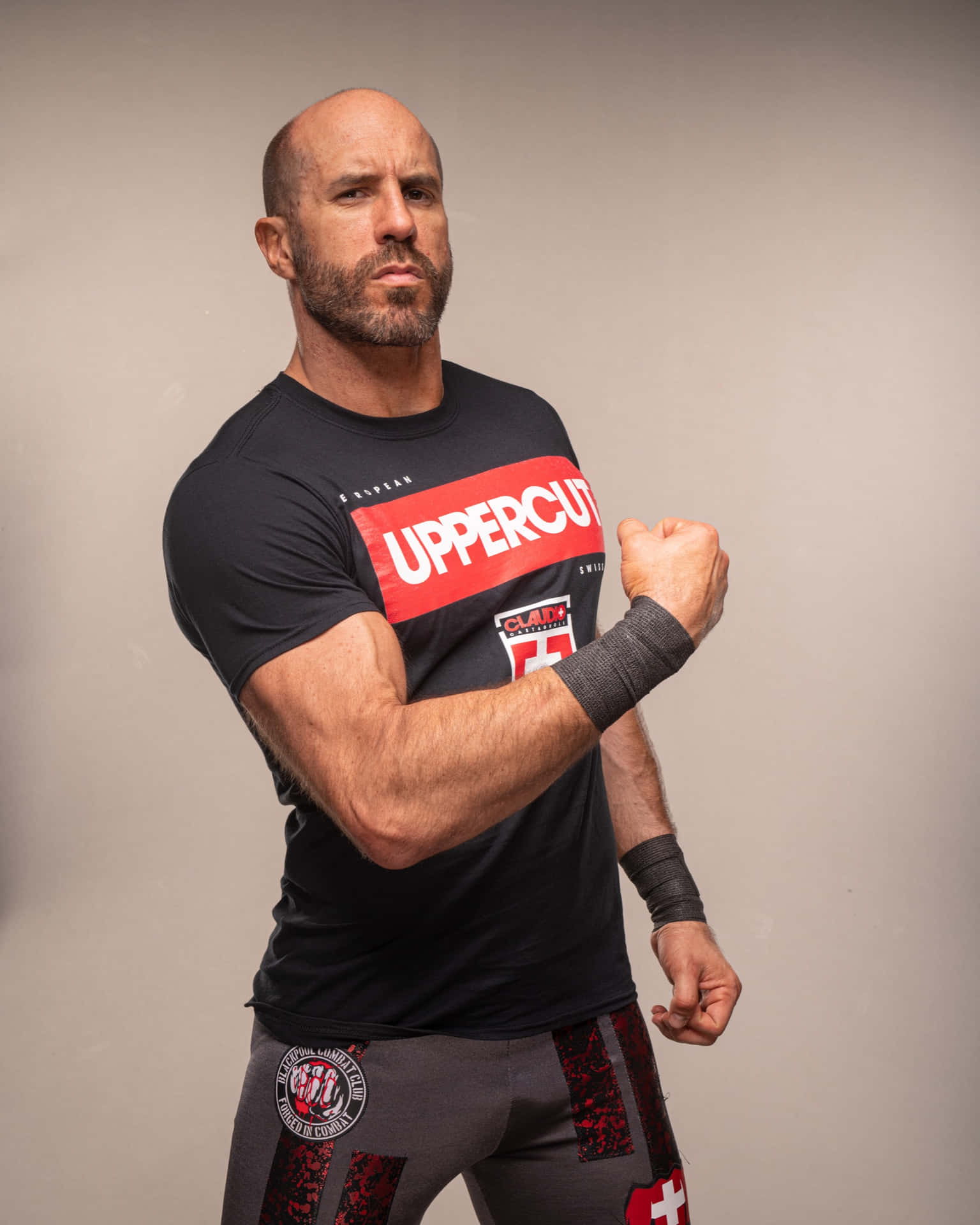 Swiss Professional Wrestler Claudio Castagnoli Black Uppercut Shirt Background