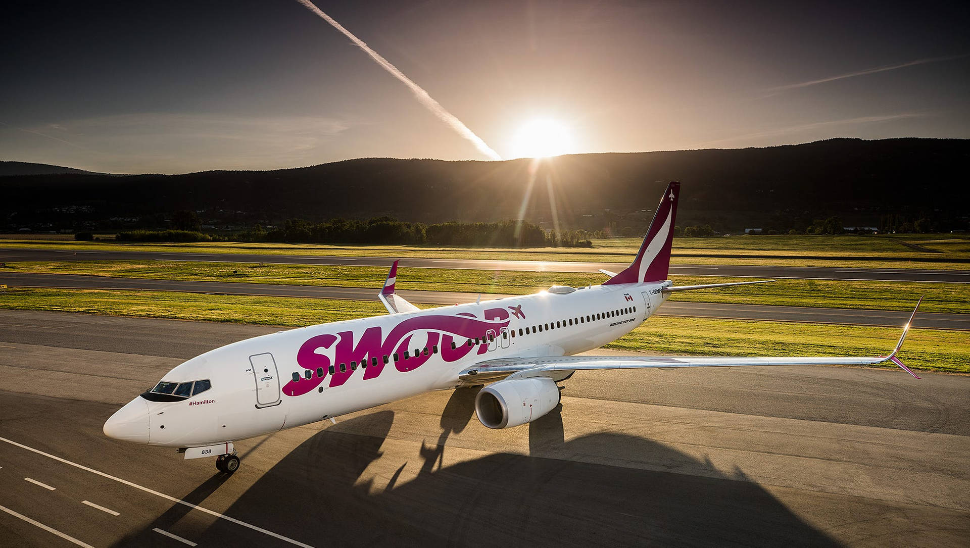 Swoop Airlines Flight At Sunrise Background