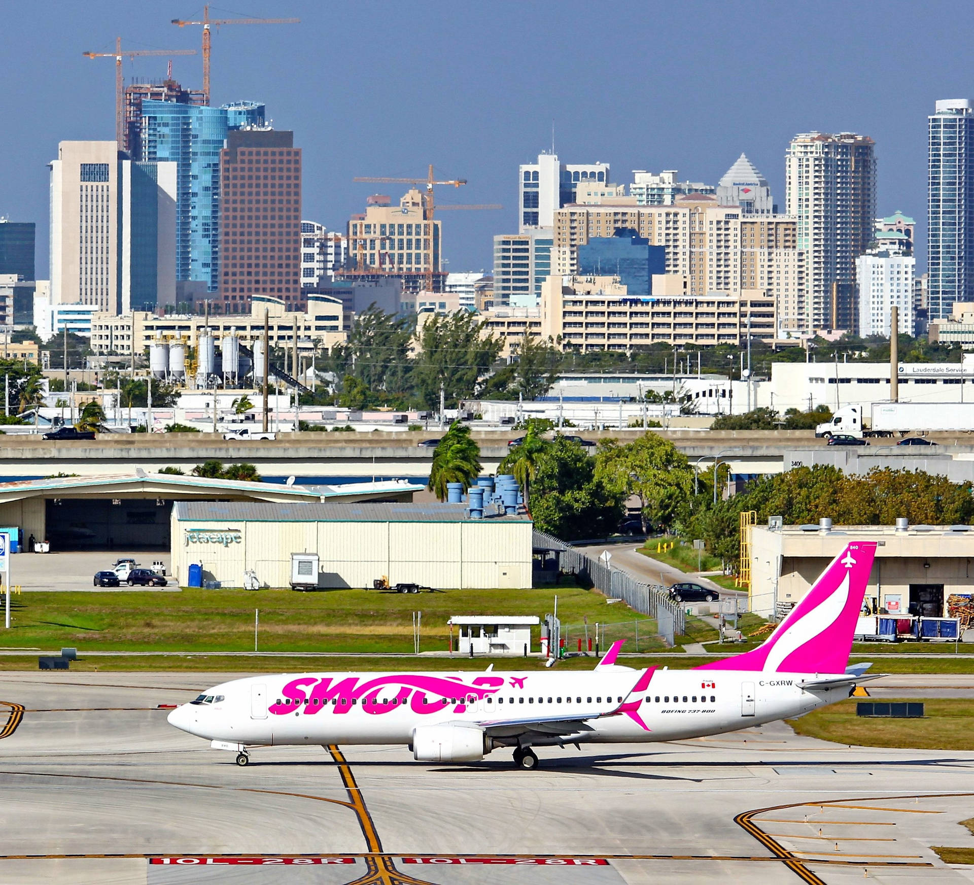 Swoop Airlines Plane With A City View Background