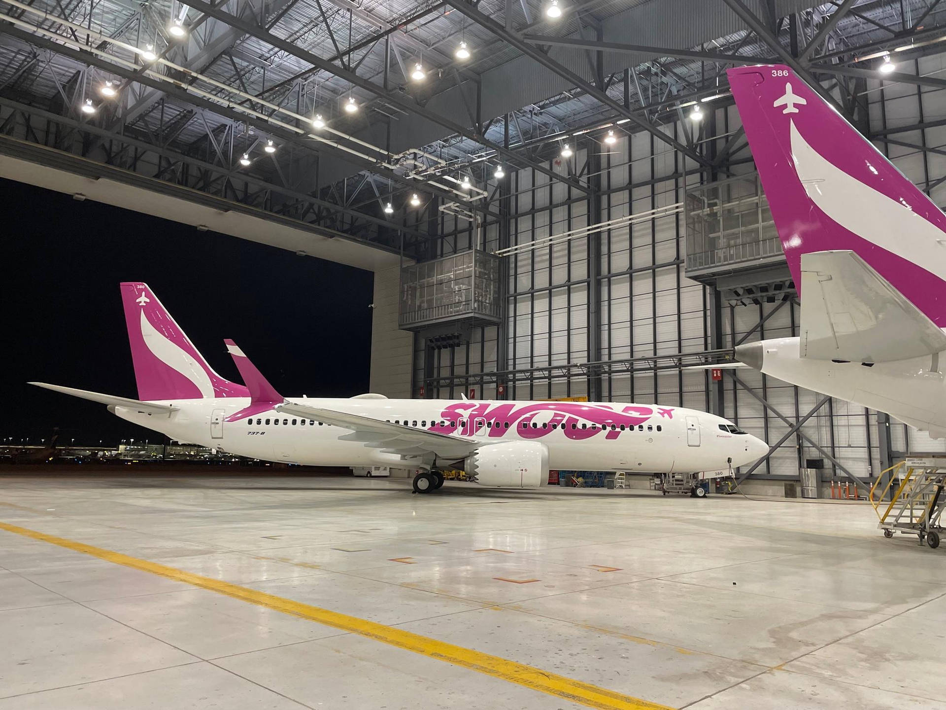 Swoop Airplane In A Hangar Background