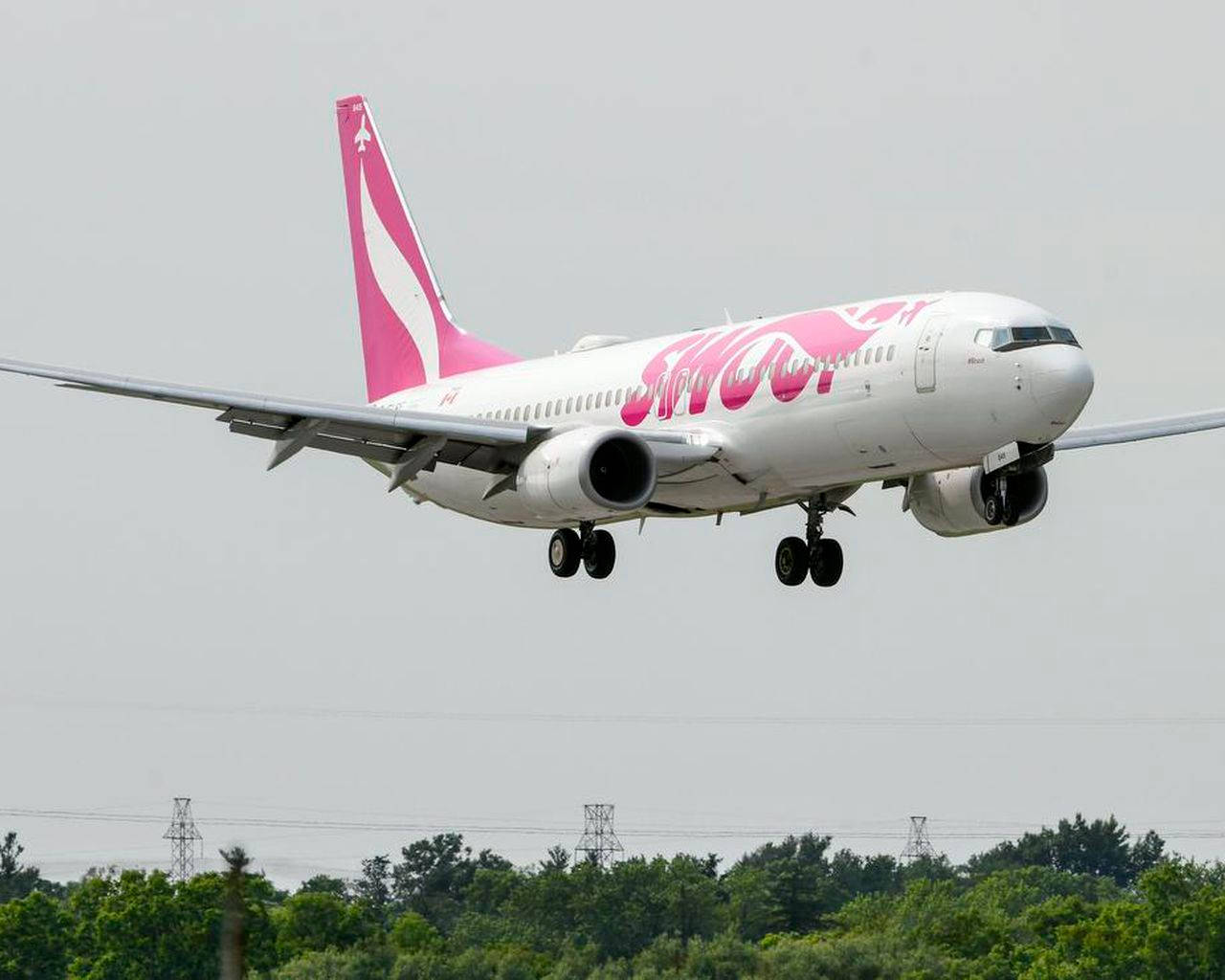 Swoop Airplane Touching Down On A Runway Background