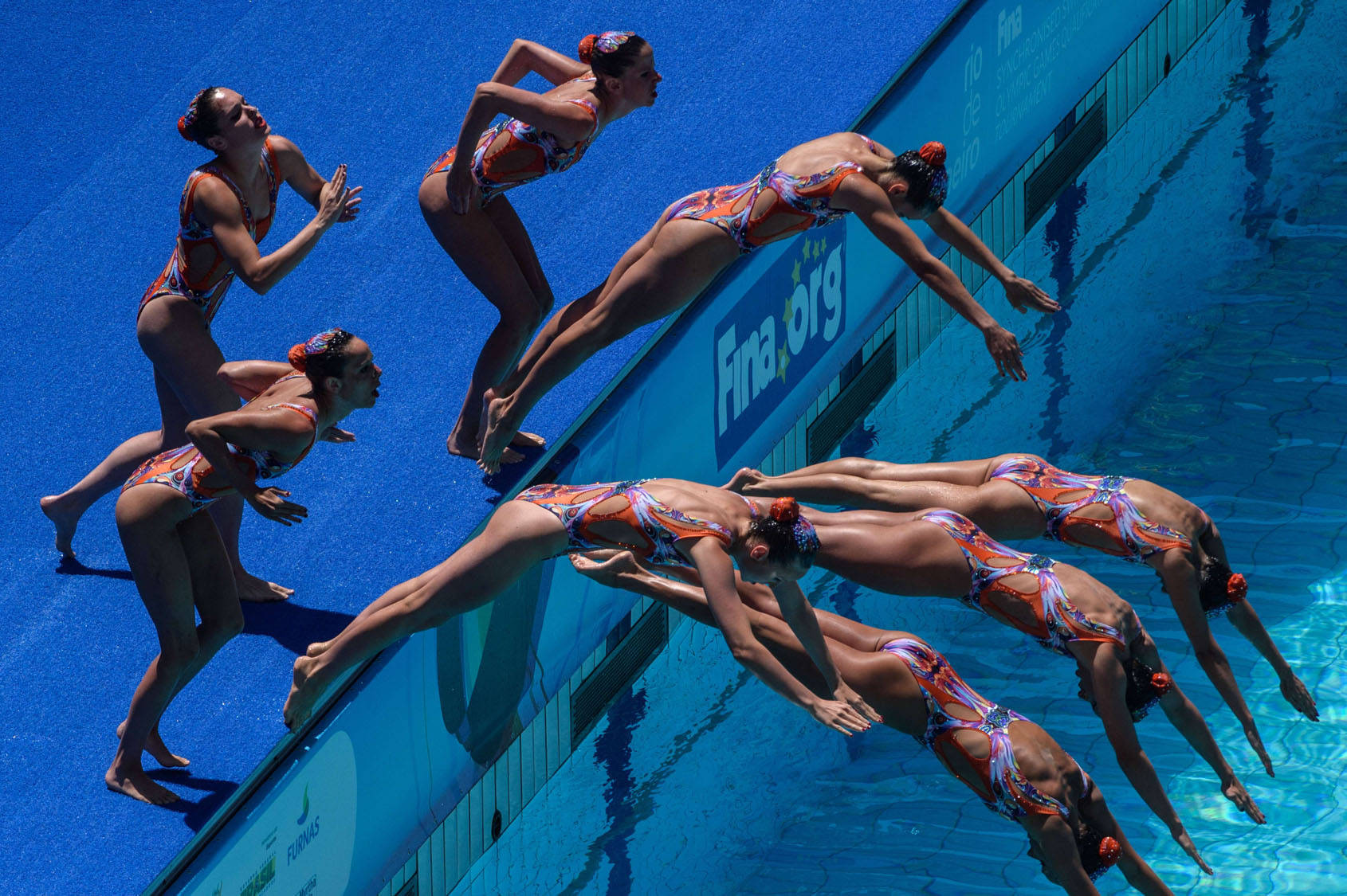 Synchronized Swimming Diving Into Pool