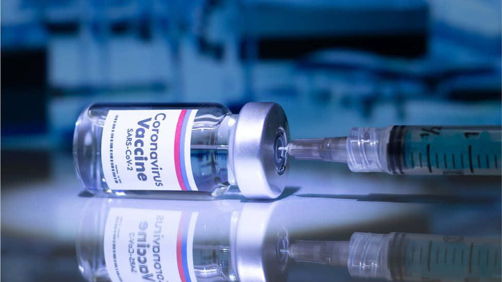 Syringe Inserted In A Vial Coronavirus Vaccine