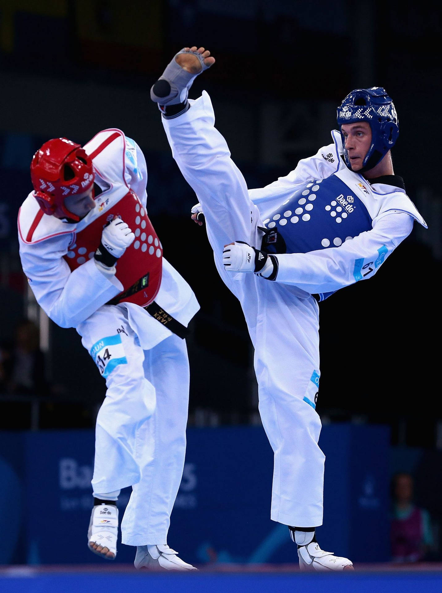 Taekwondo Athlete In Action At The Baku European Games Background