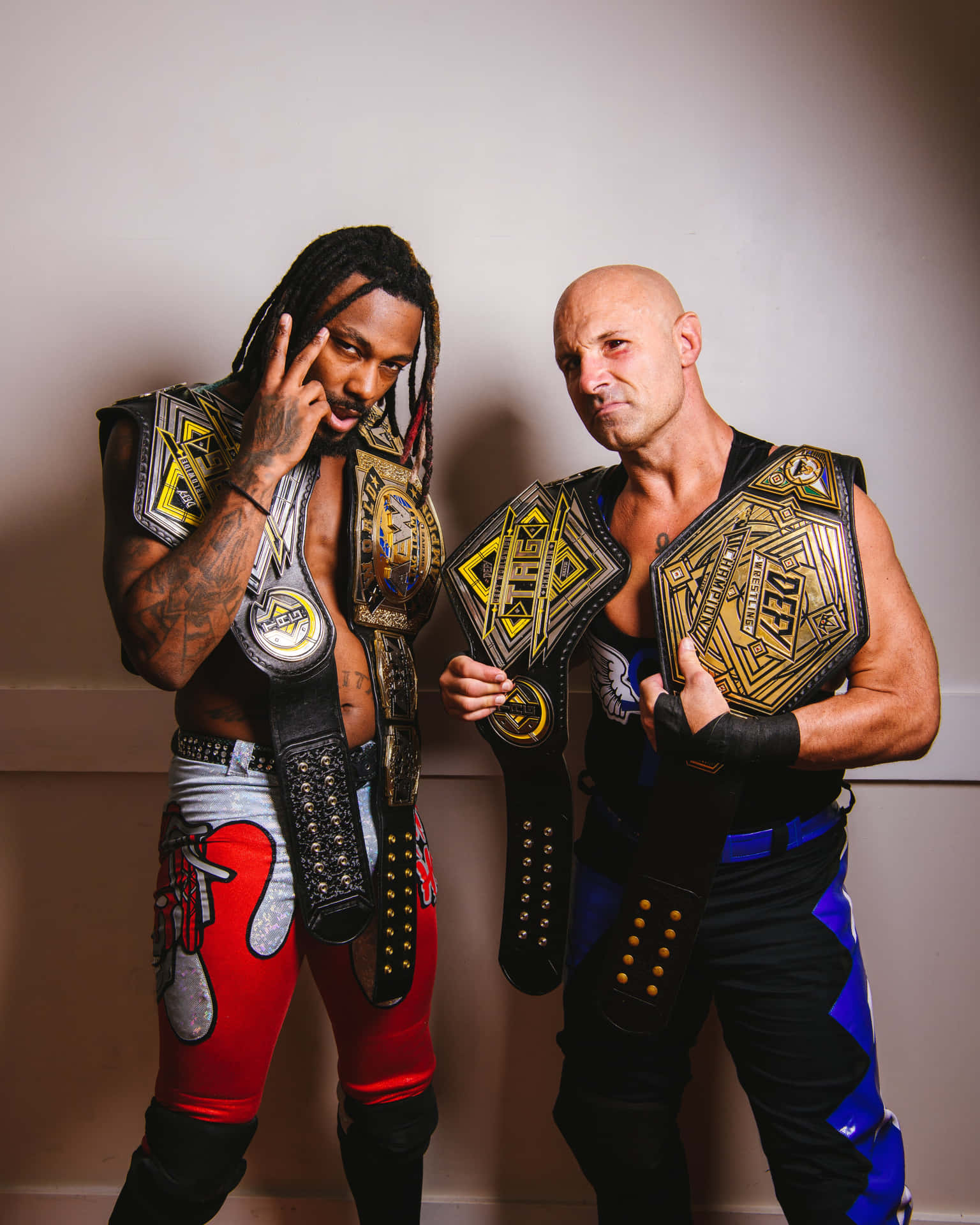 Tag Team Champions Pose With Belts Background