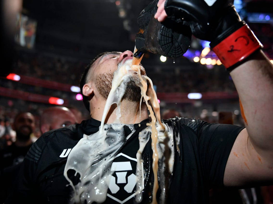 Tai Tuivasa Drinking Beer With Hot Sauce Background