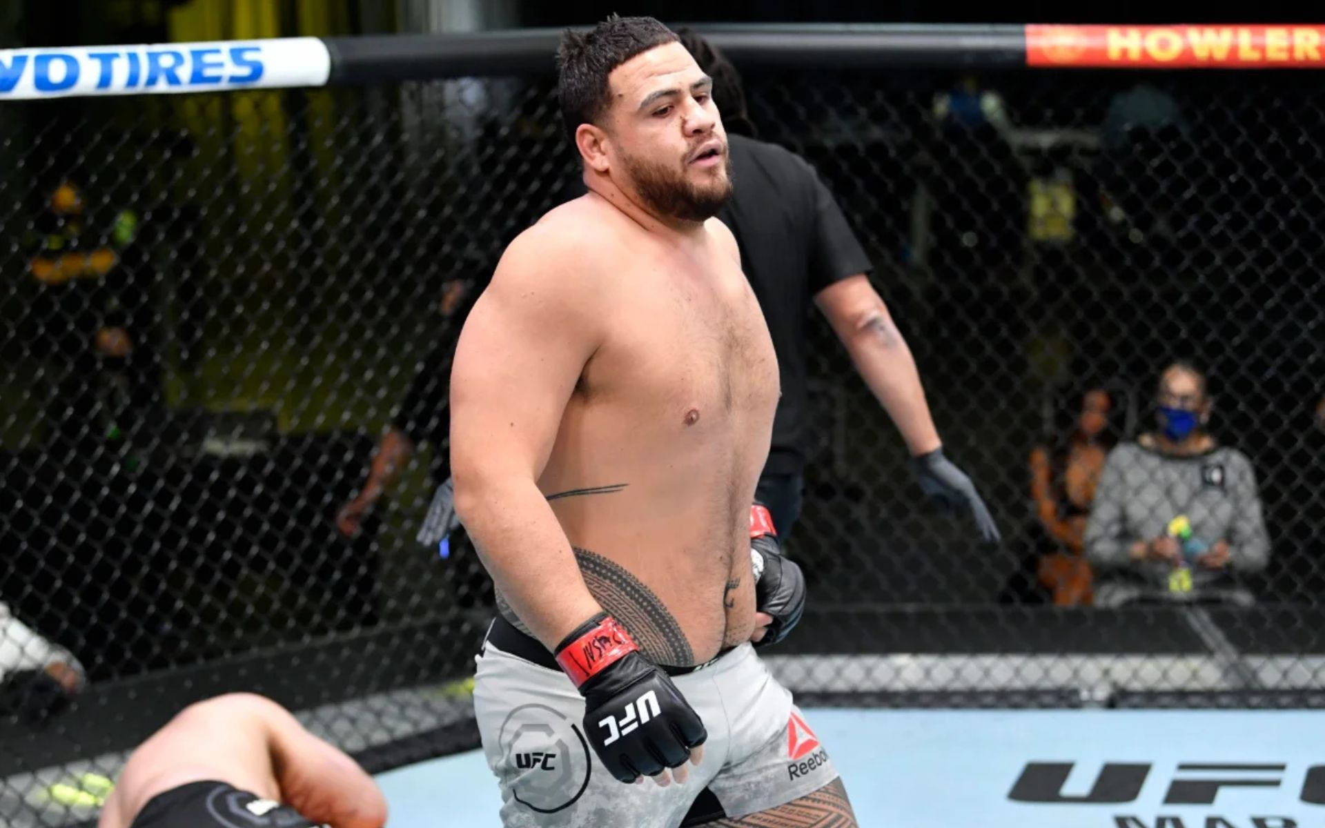 Tai Tuivasa Walking Away From Harry Hunsucker Background