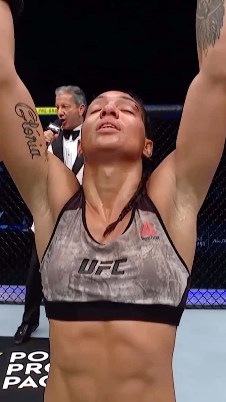 Taila Santos Celebrating Victory With Arms Up Background