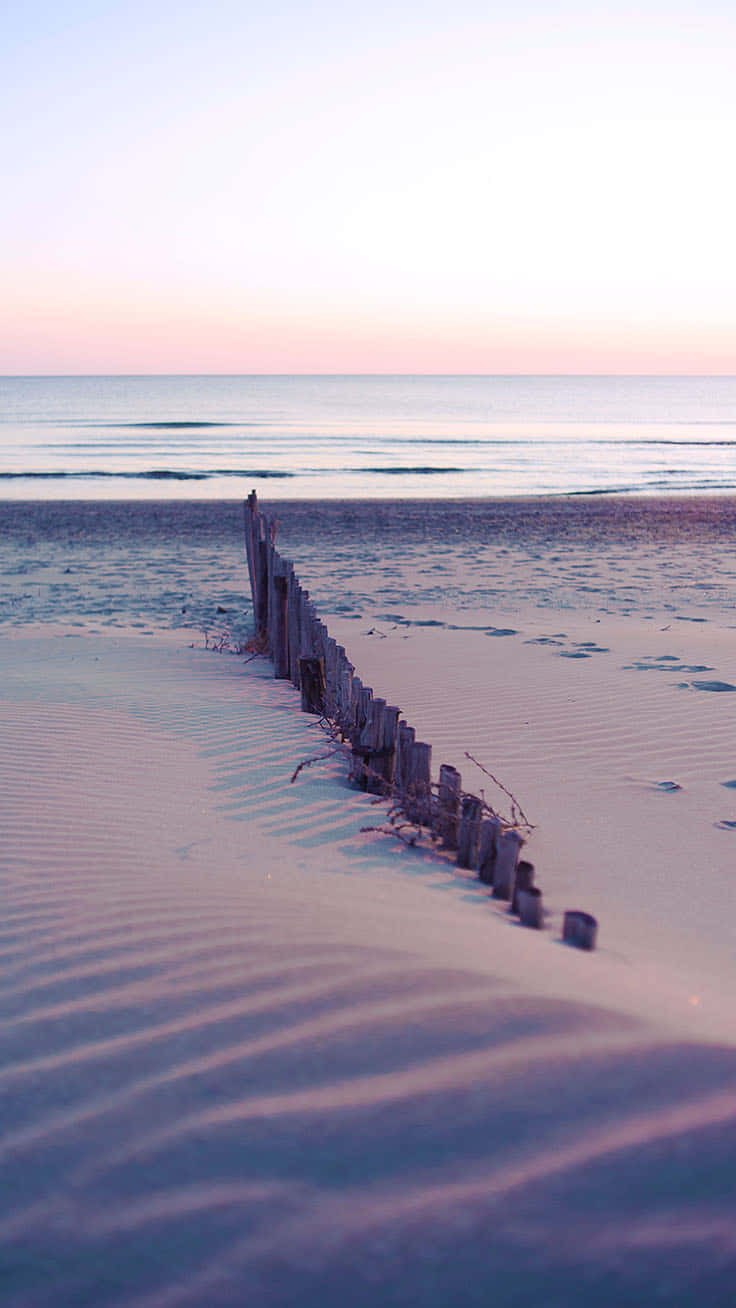 Take A Break From The Hustle And Bustle And Soak Up Some Much-needed Relaxation At The Beach With Your Iphone. Background