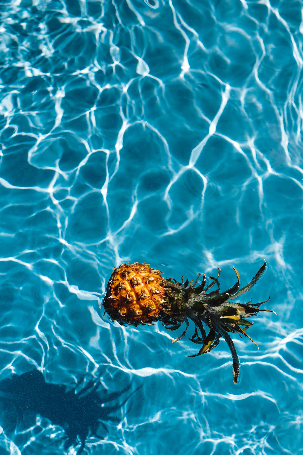 Take A Dive Into Relaxation With This Pineapple In The Pool. Background