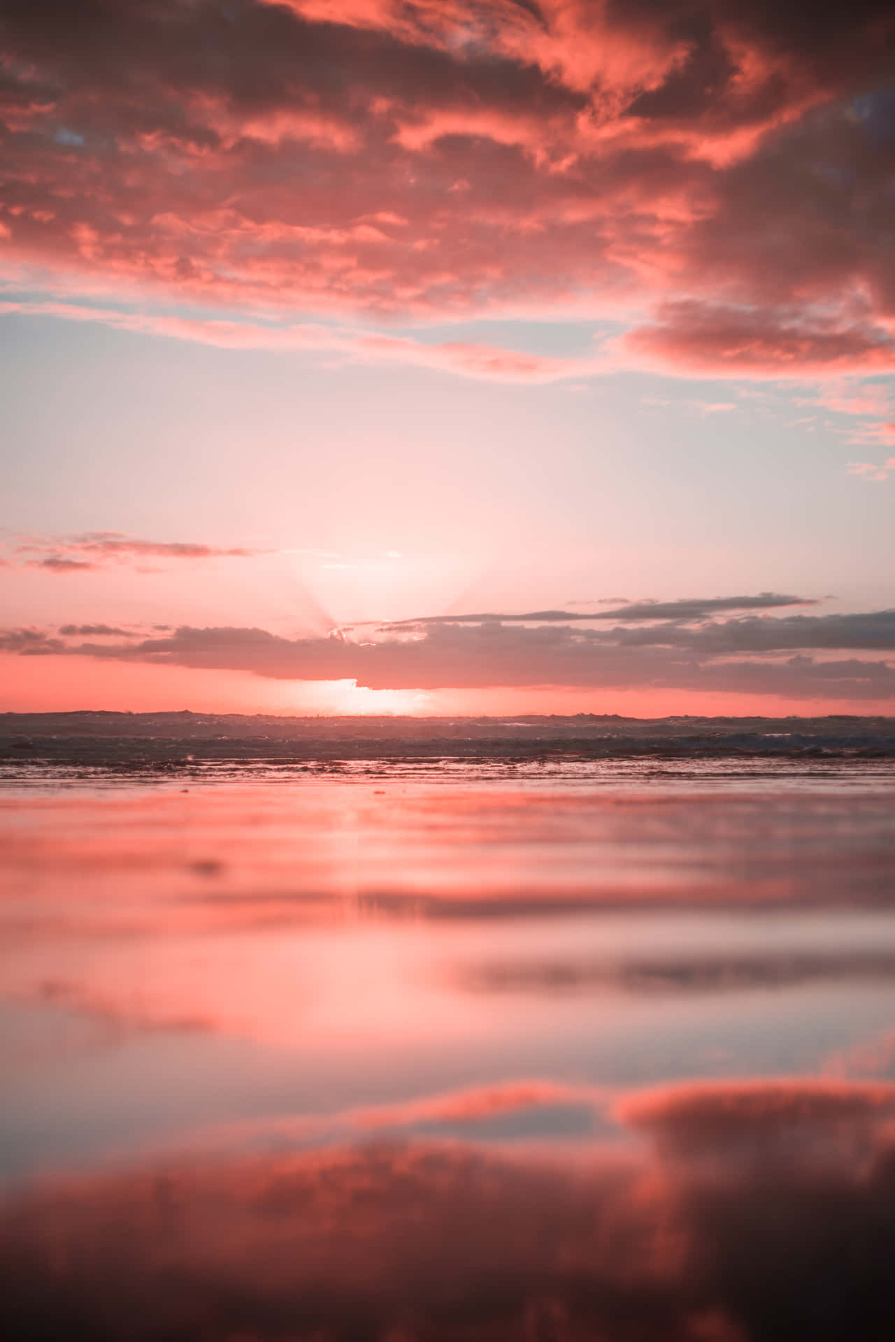 Take In The Majestic Beauty Of A Breathtaking Pink Beach Sunset. Background