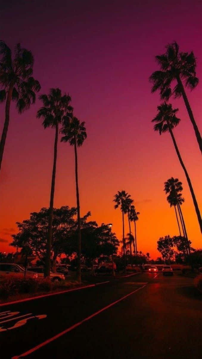 Take In The View At Sunset Beach With Your Trusty Iphone Background