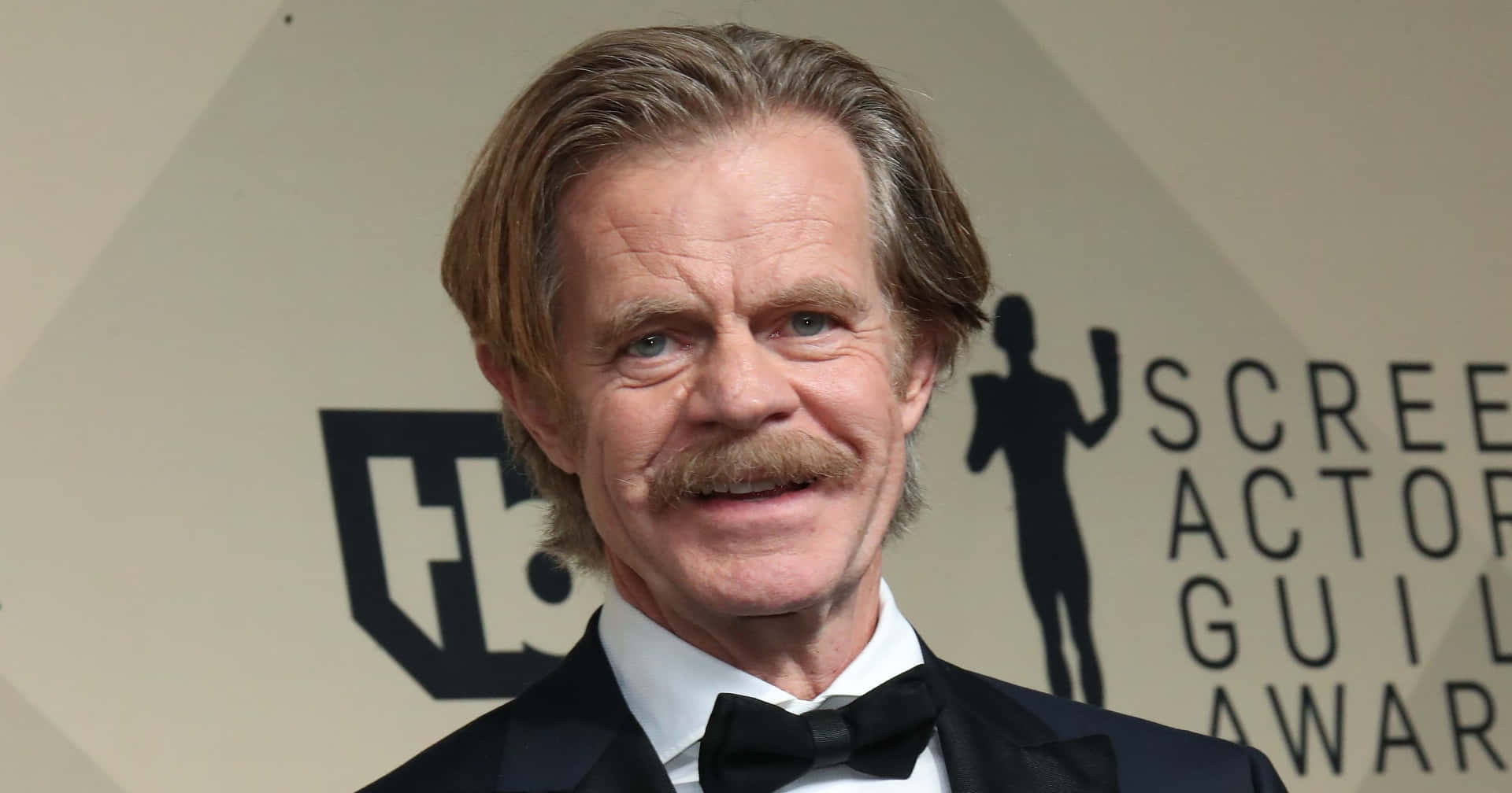 Talented Actor William H. Macy Looking Pensively Into The Distance Background