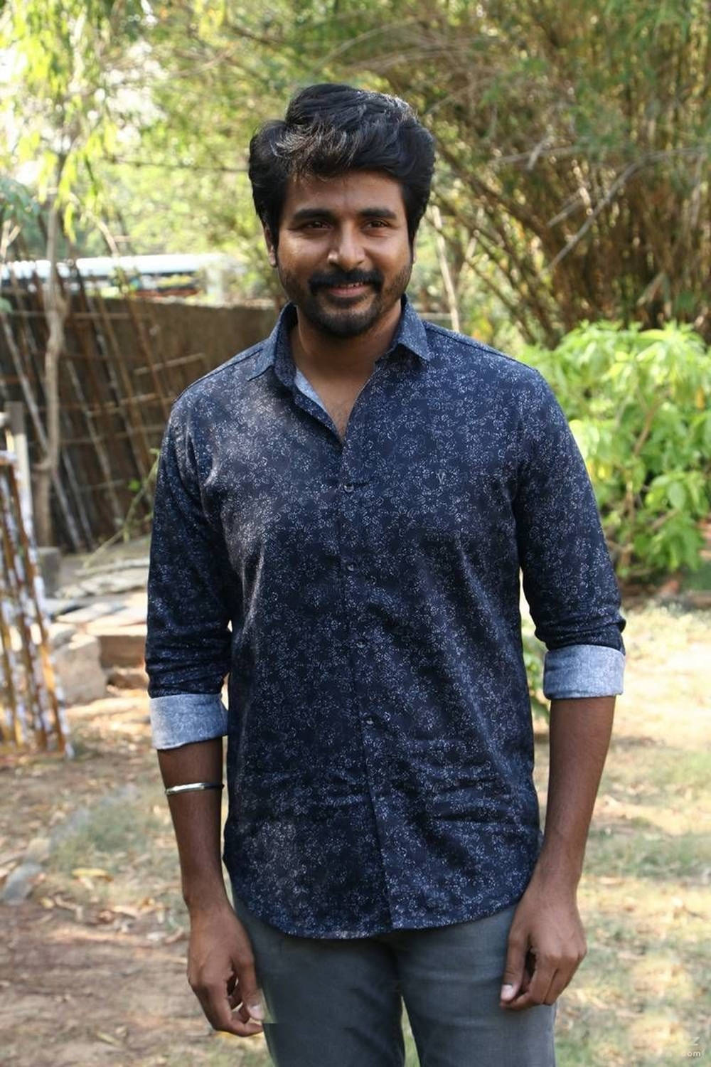 Talented South Indian Actor Sivakarthikeyan In A Stylish Dark Blue Shirt Background