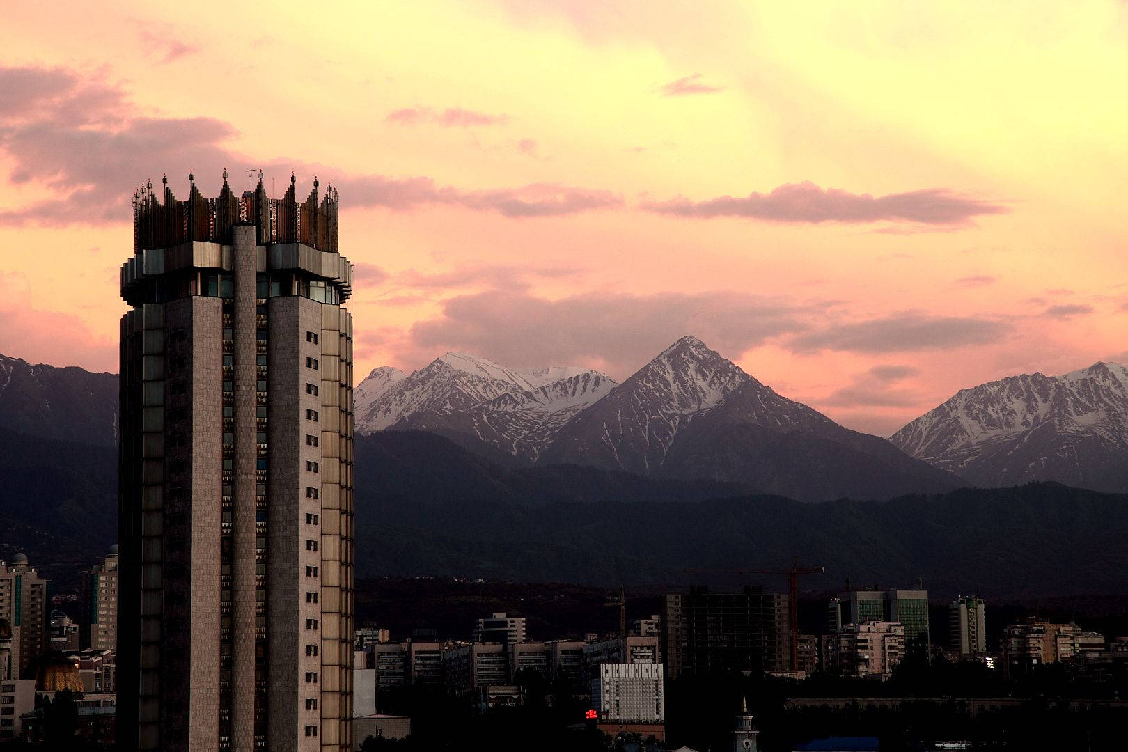 Tall Almaty Building In Sunset Background