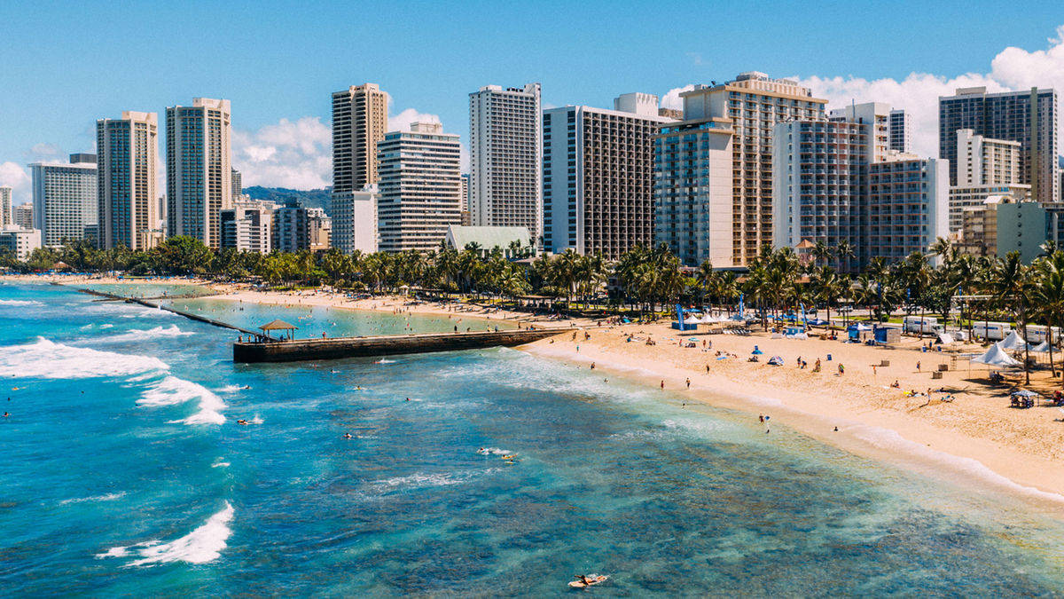 Tall Buildings Along Oahu Beach Background