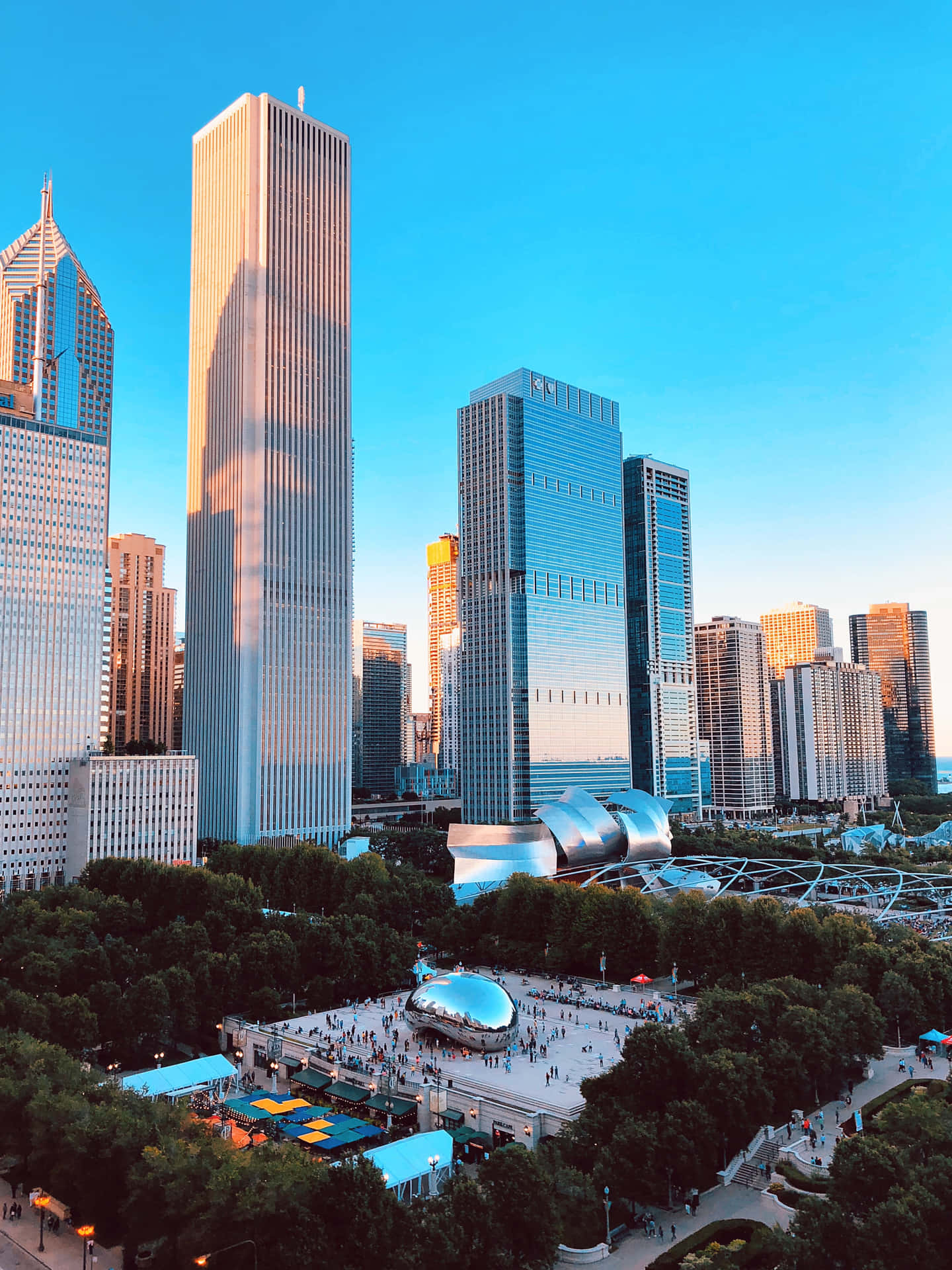 Tall Buildings Near Cloud Gate In Chicago Background