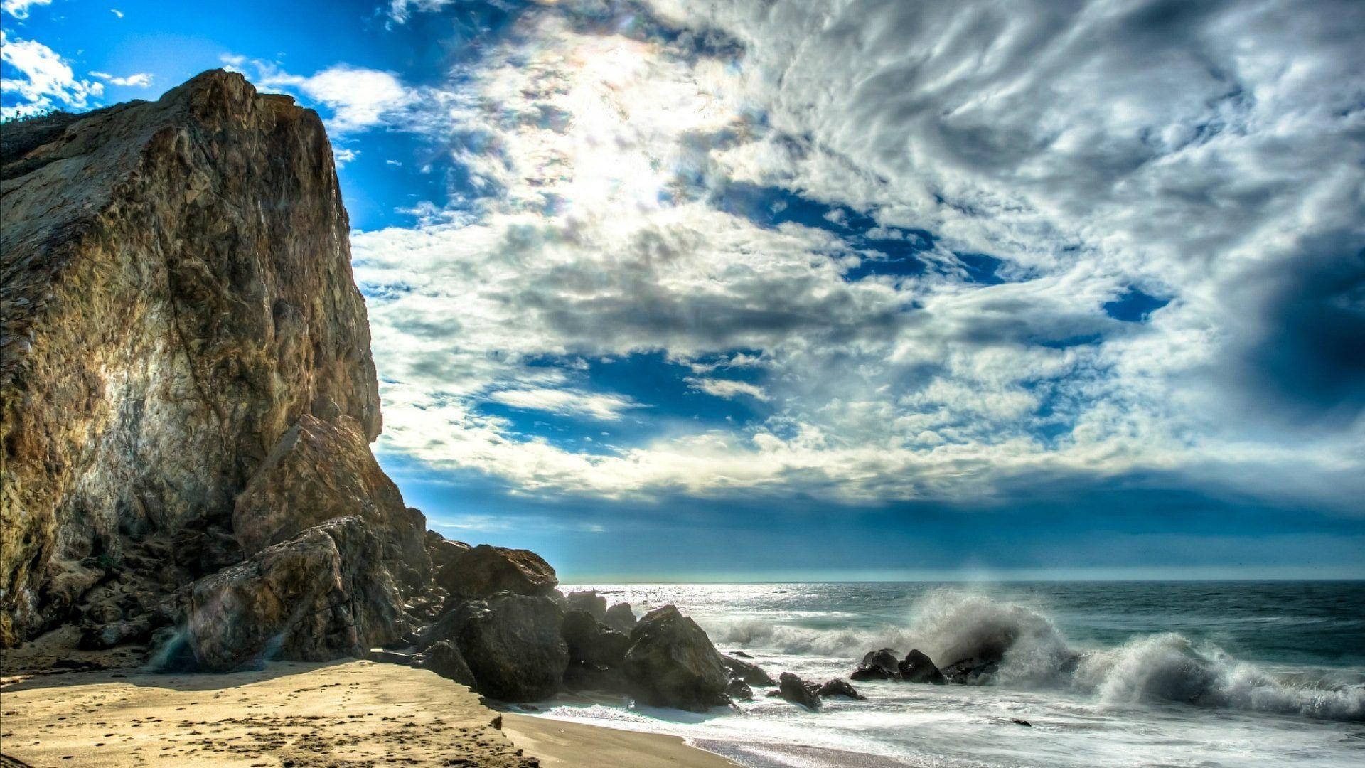 Tall Cliff On Malibu Beach Background