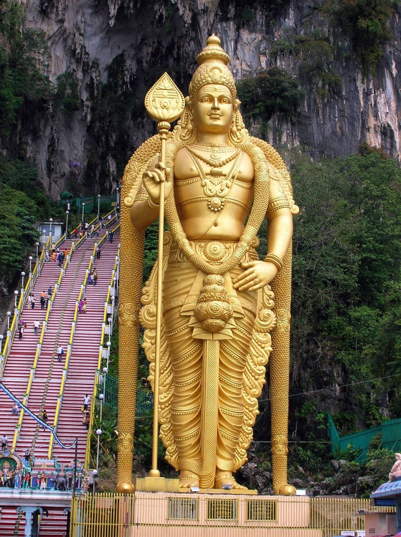 Tall Golden Murugan Statue Background