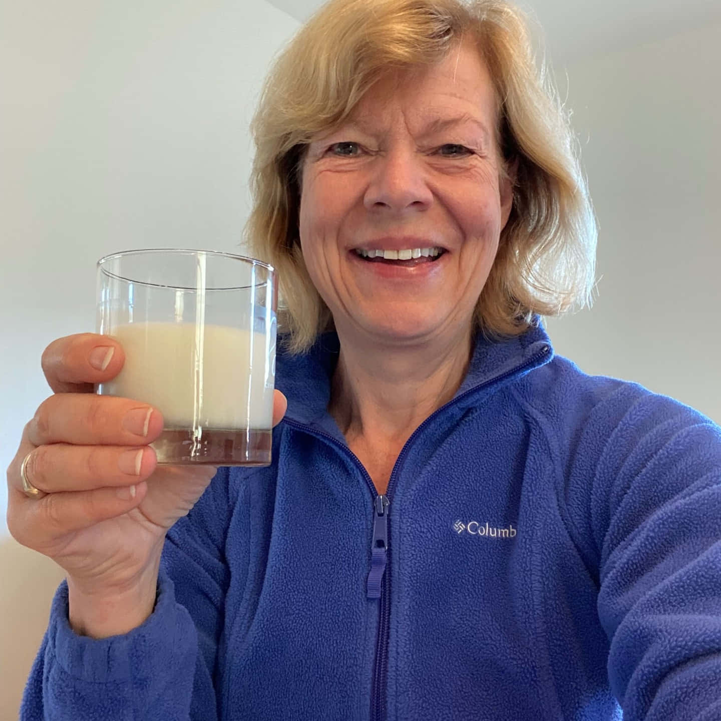 Tammy Baldwin With Glass Of Milk Background