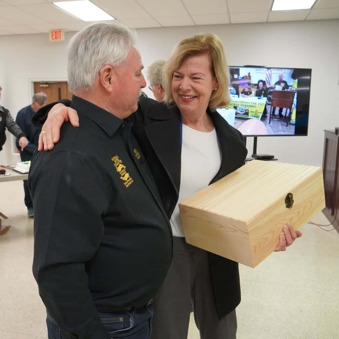 Tammy Baldwin With Wooden Box Background