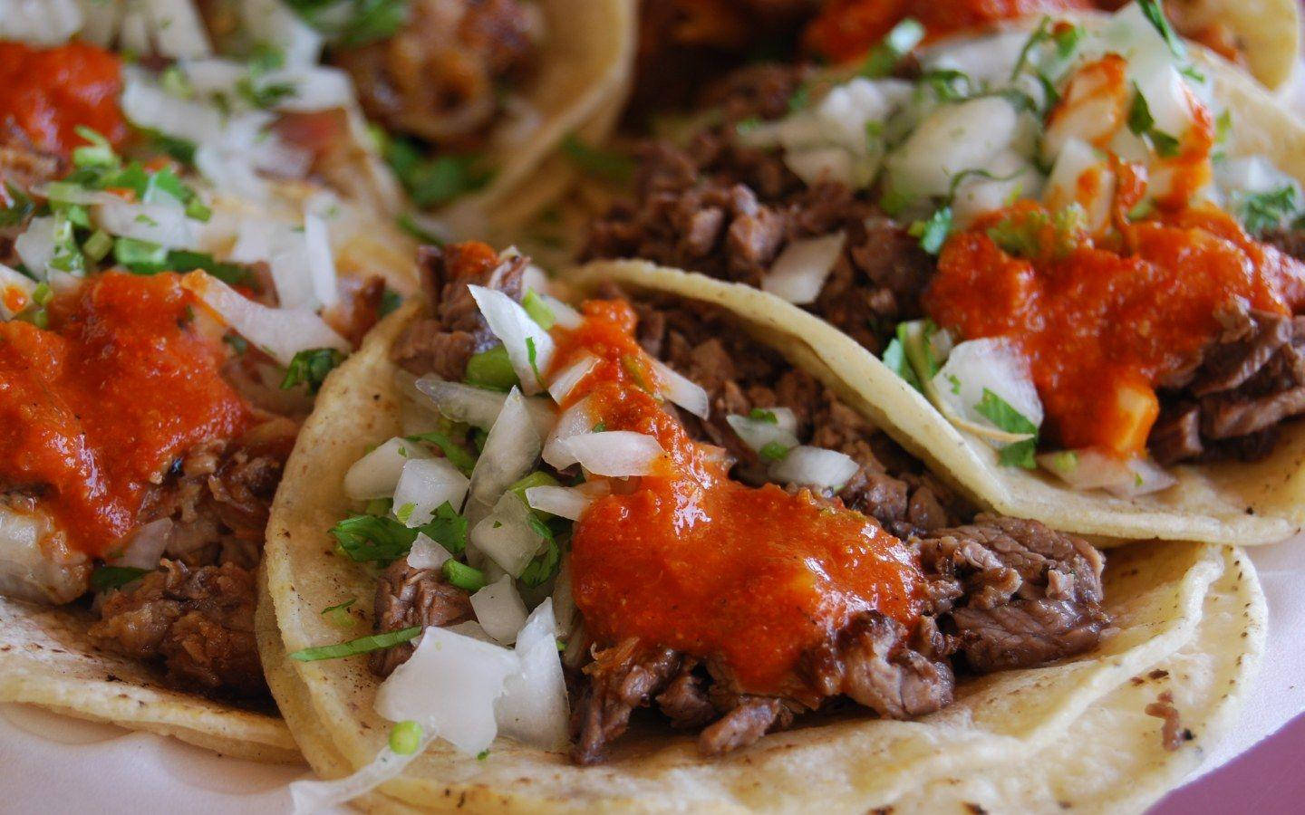 Tantalizing Tacos Al Pastor With Vibrant Spicy Salsa Background