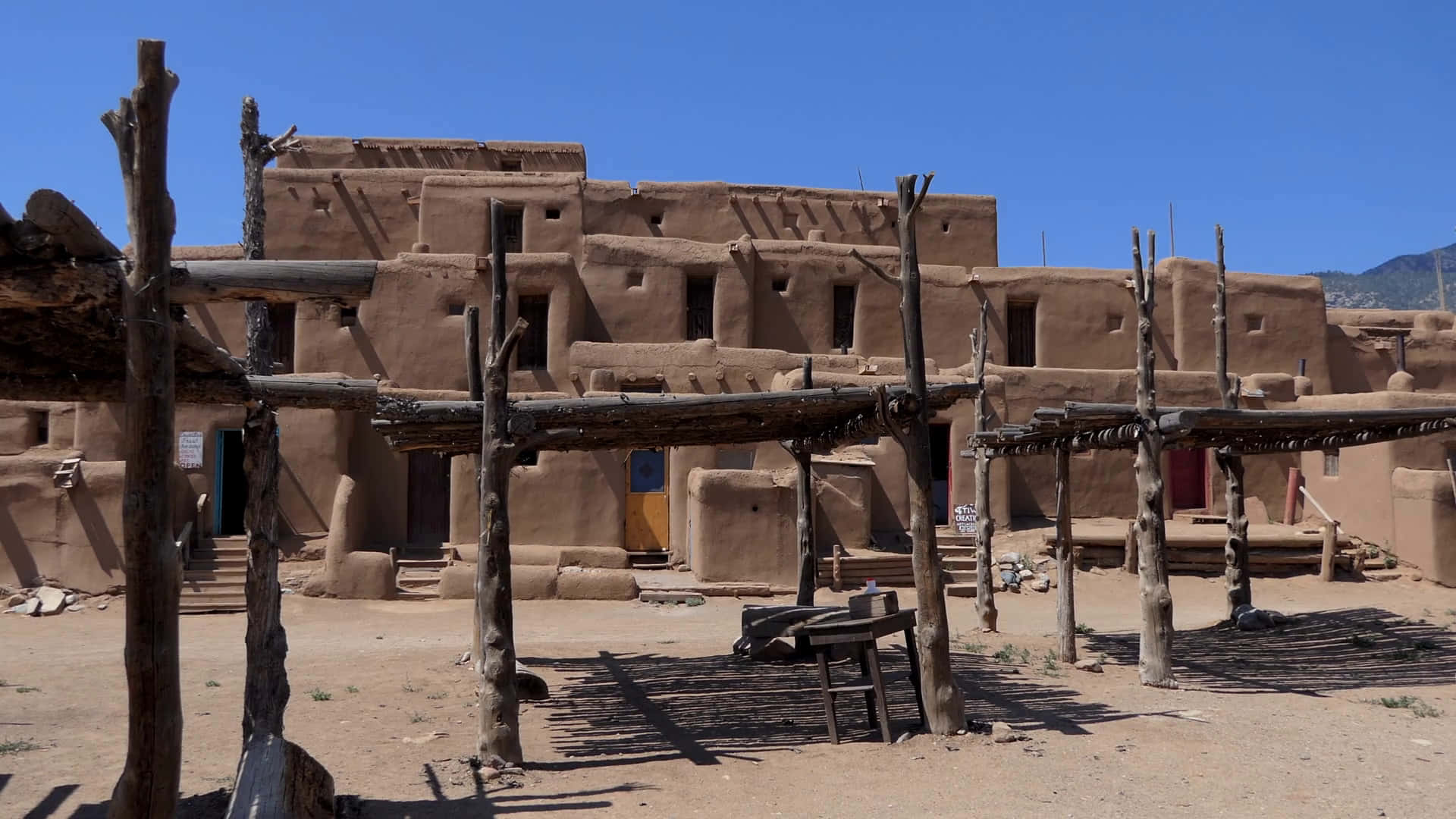 Taos Pueblo Timber Sheds Background