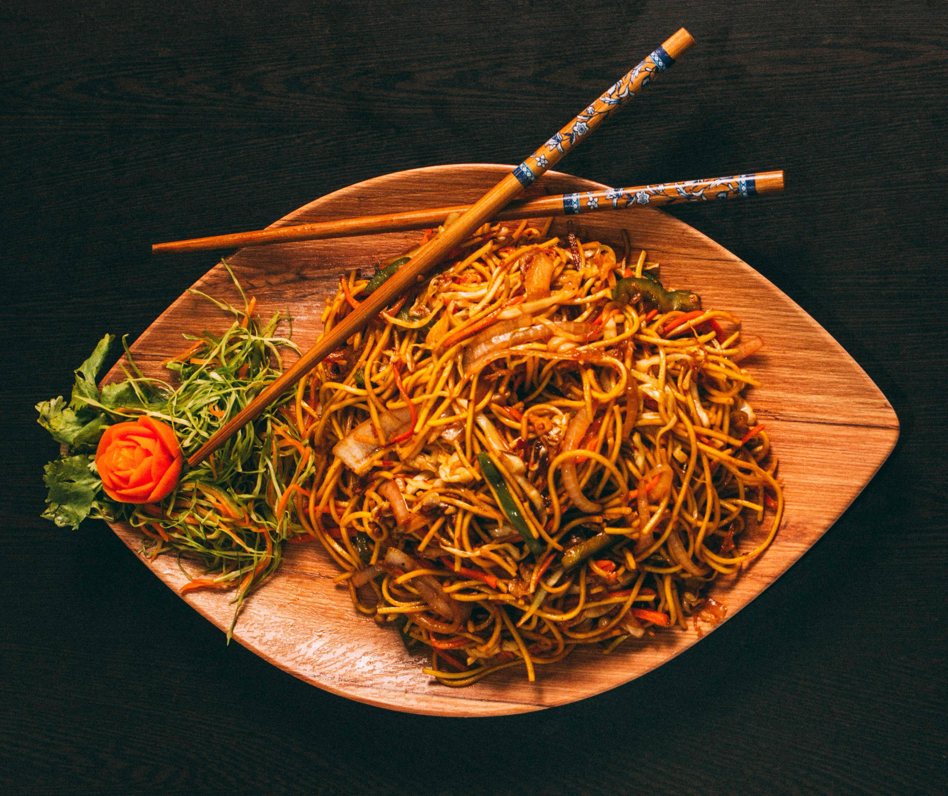 Tasty Authentic Ramen Dish Being Enjoyed With Chopsticks Background