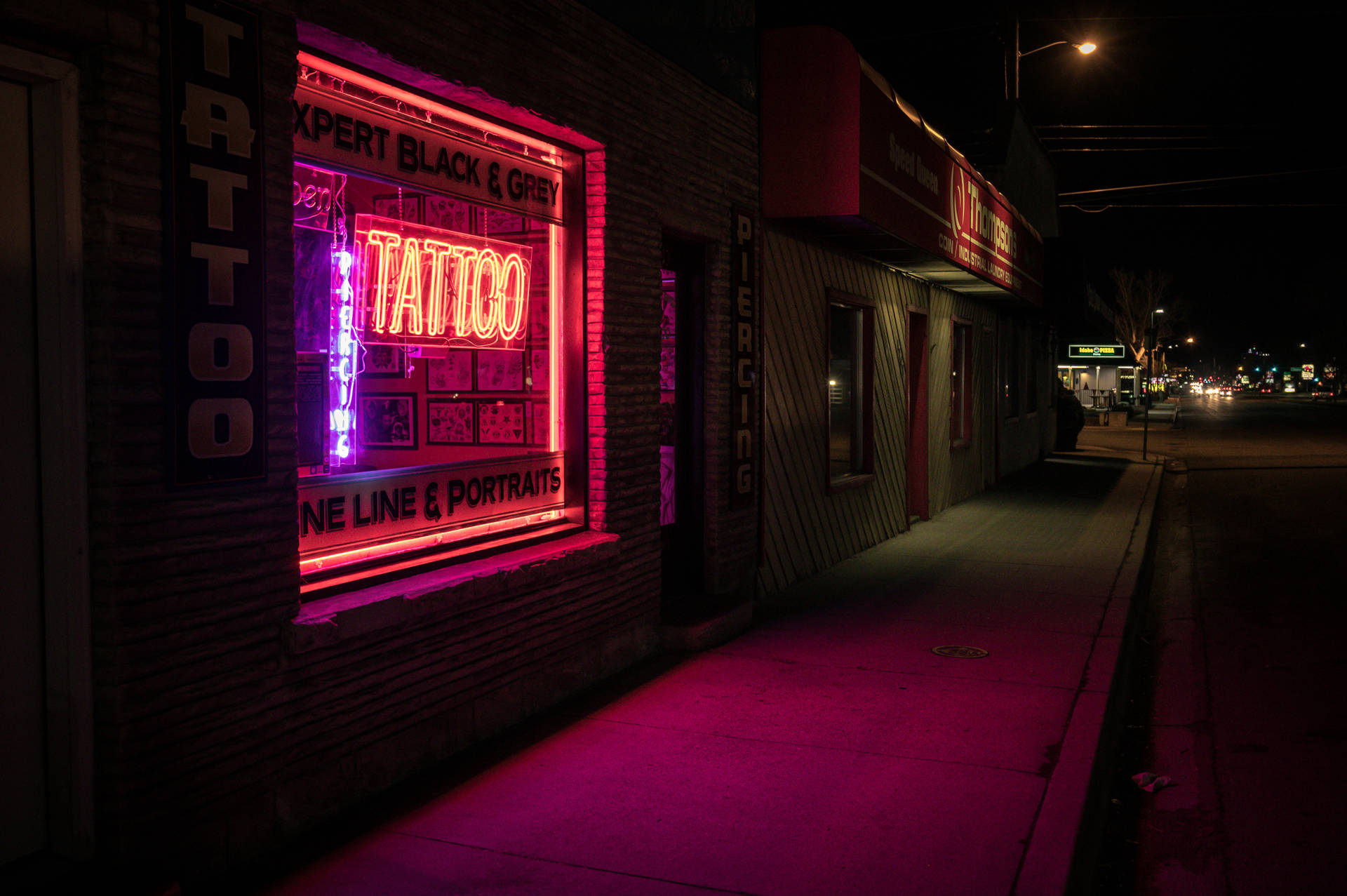 Tattoo Neon Sign In Window Background