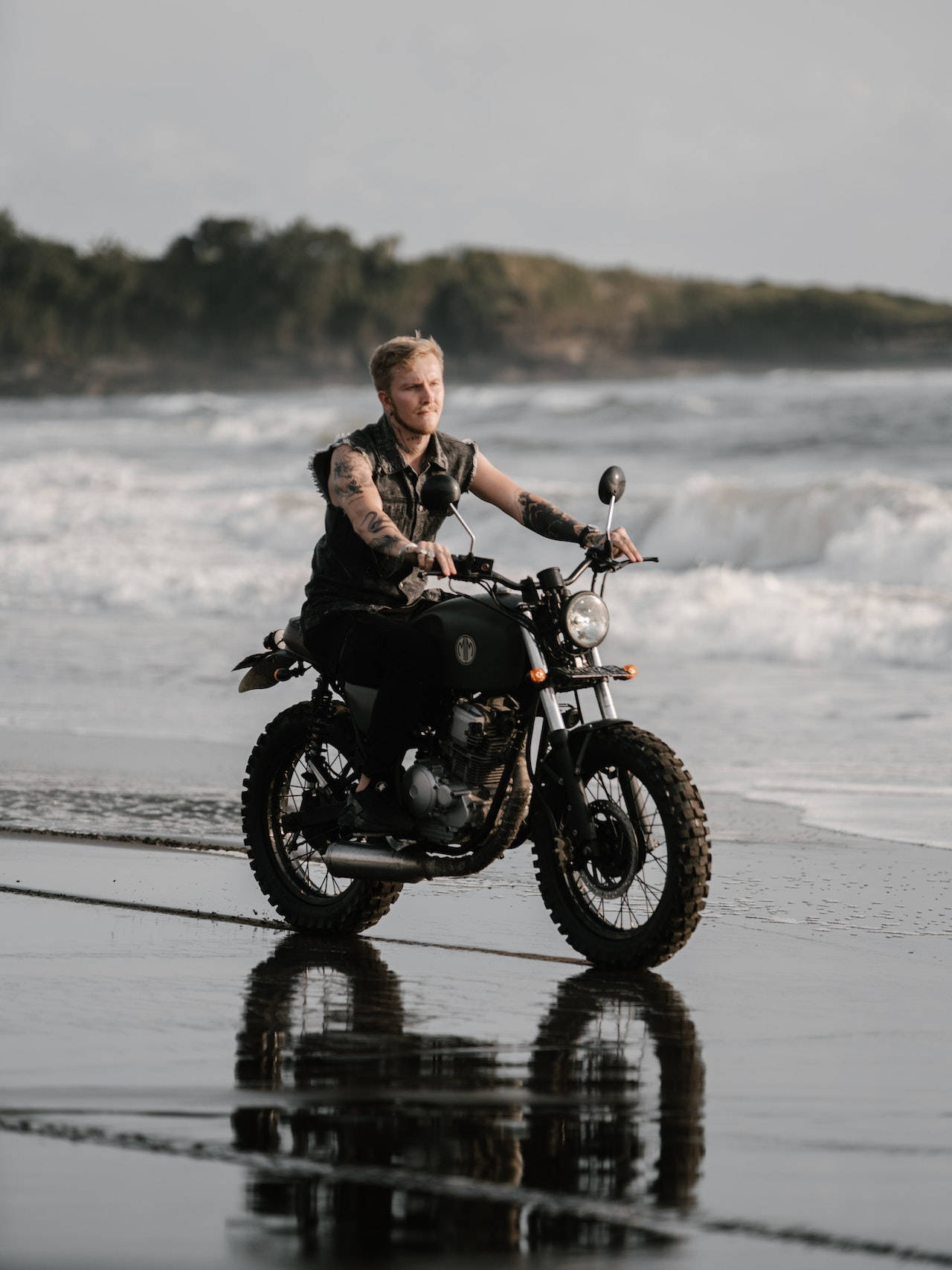 Tattooed Bike Rider Driving Through The Beach