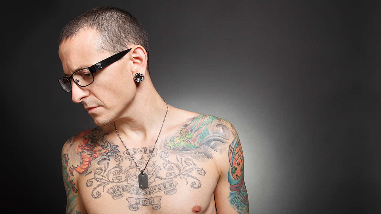 Tattooed Manwith Glasses Background