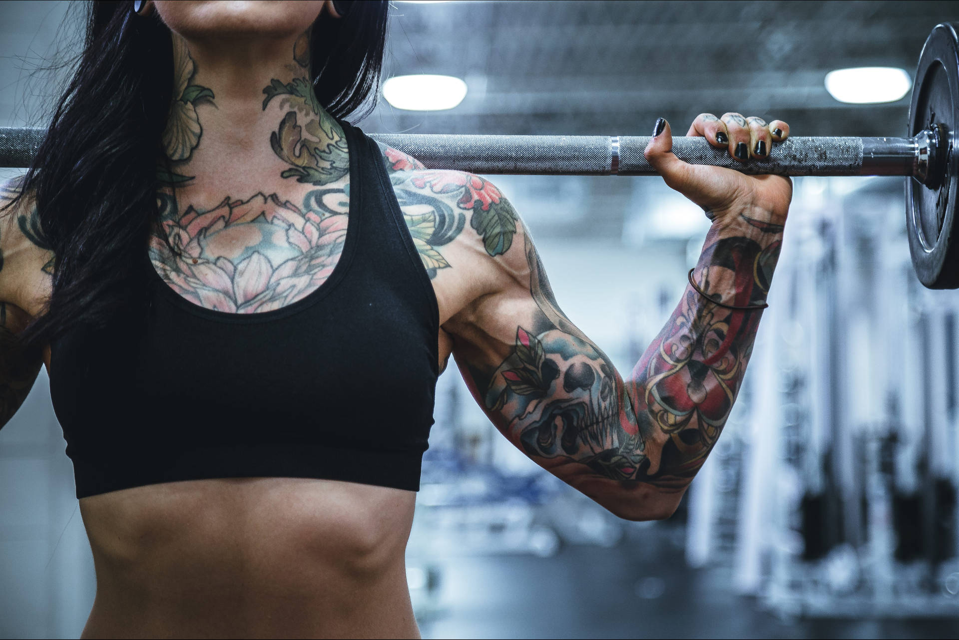 Tattooed Woman With Barbell Background