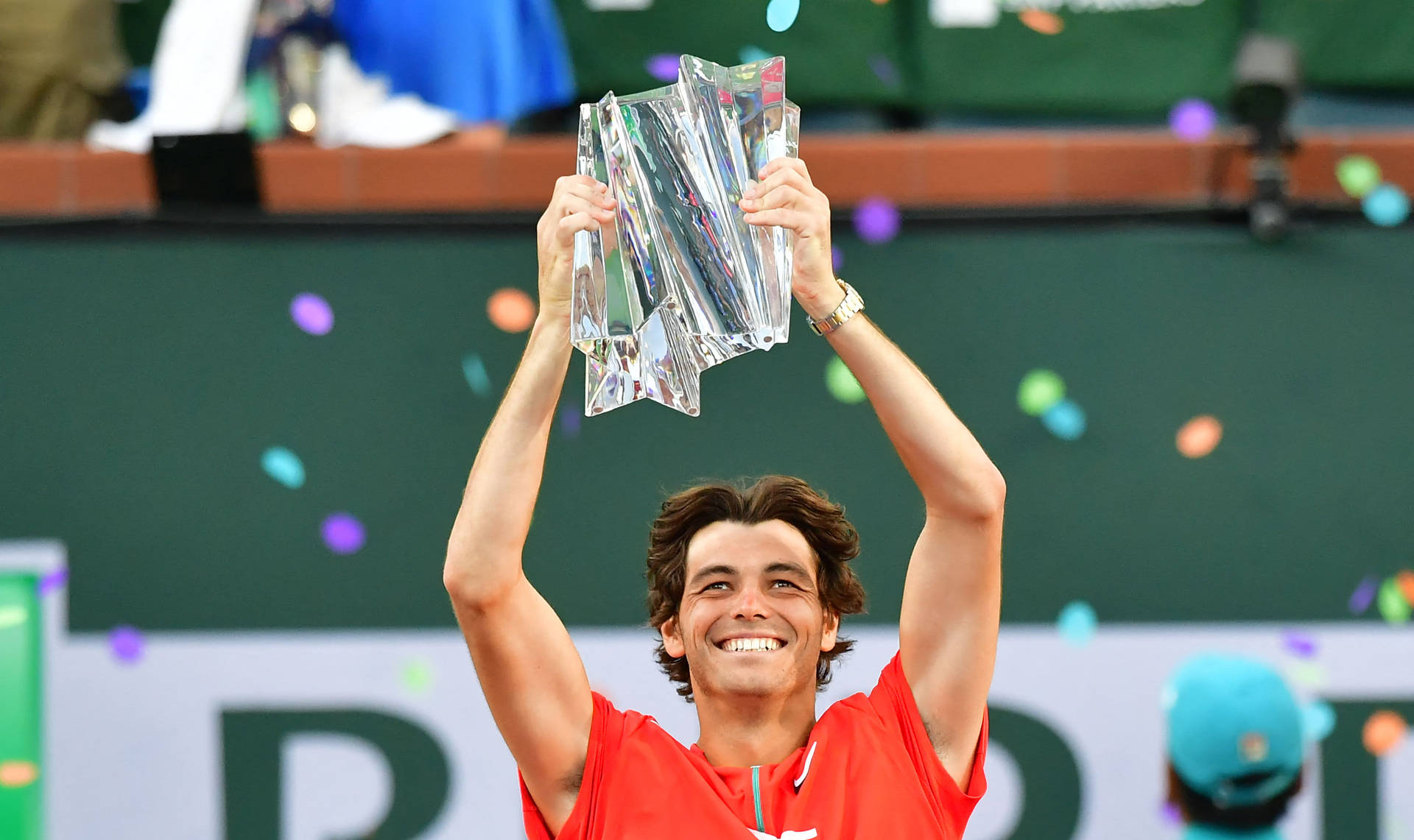 Taylor Fritz Holding A Trophy Background