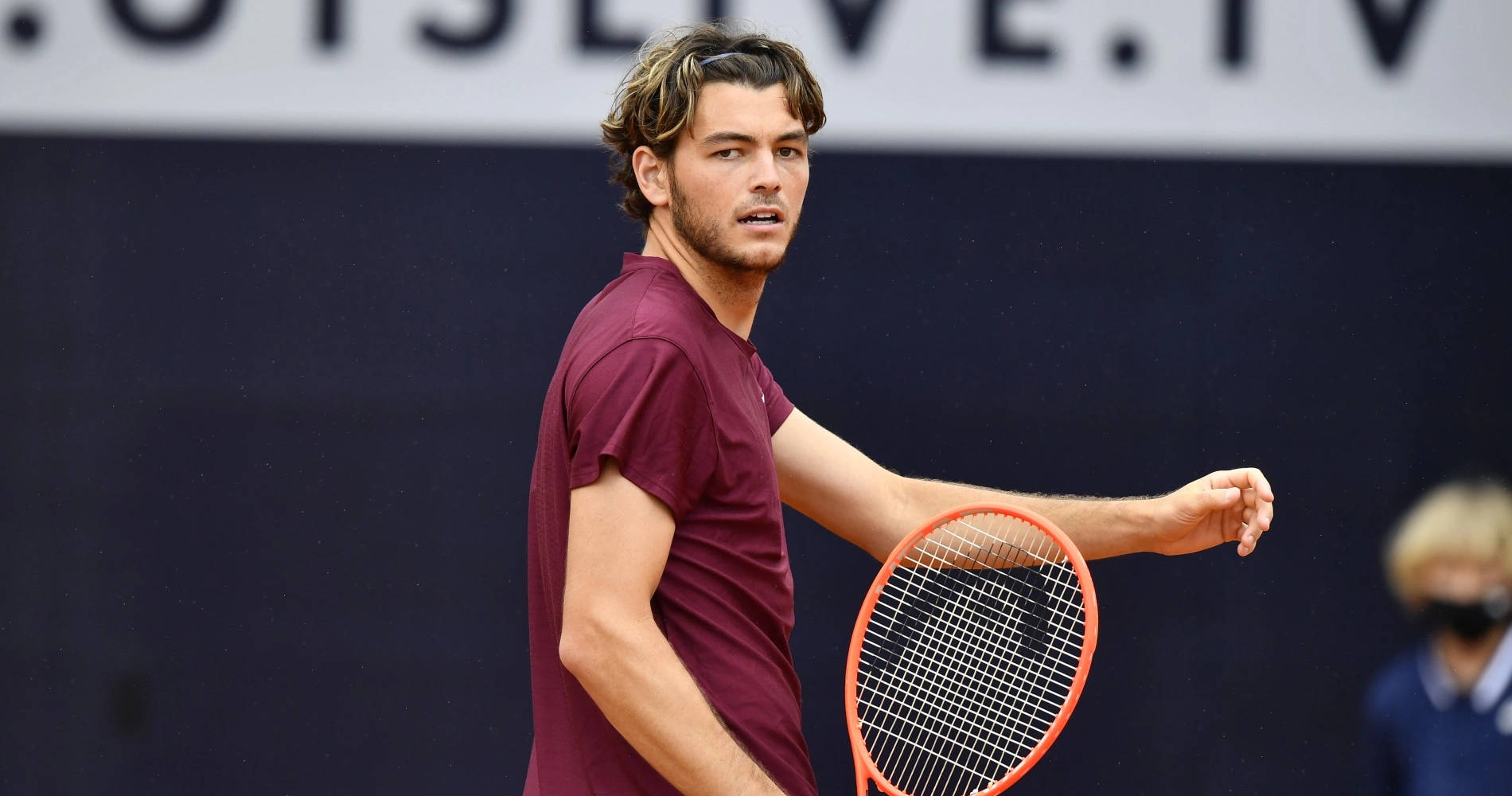 Taylor Fritz In Maroon Shirt Background