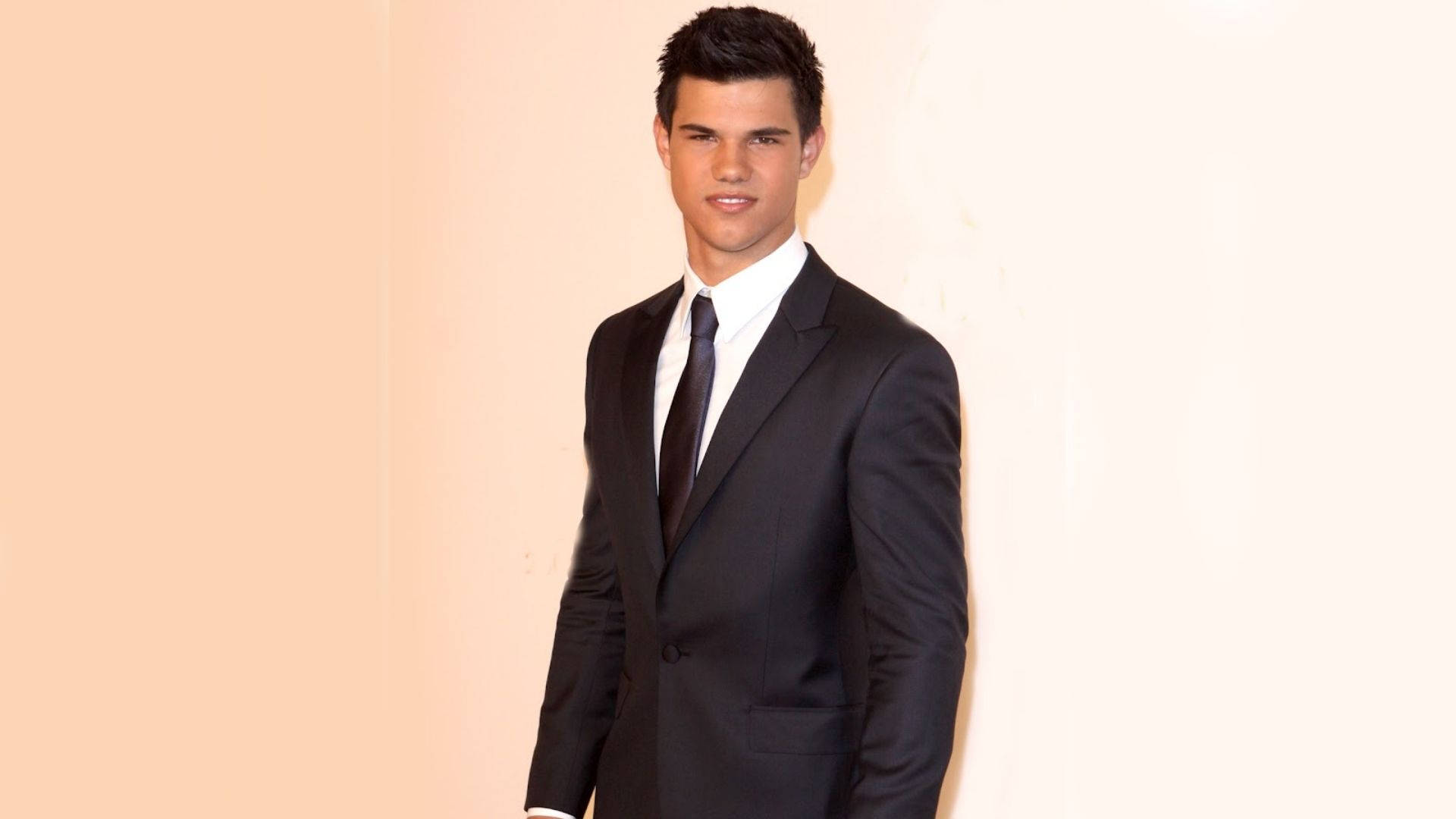 Taylor Lautner In A Black Suit Background